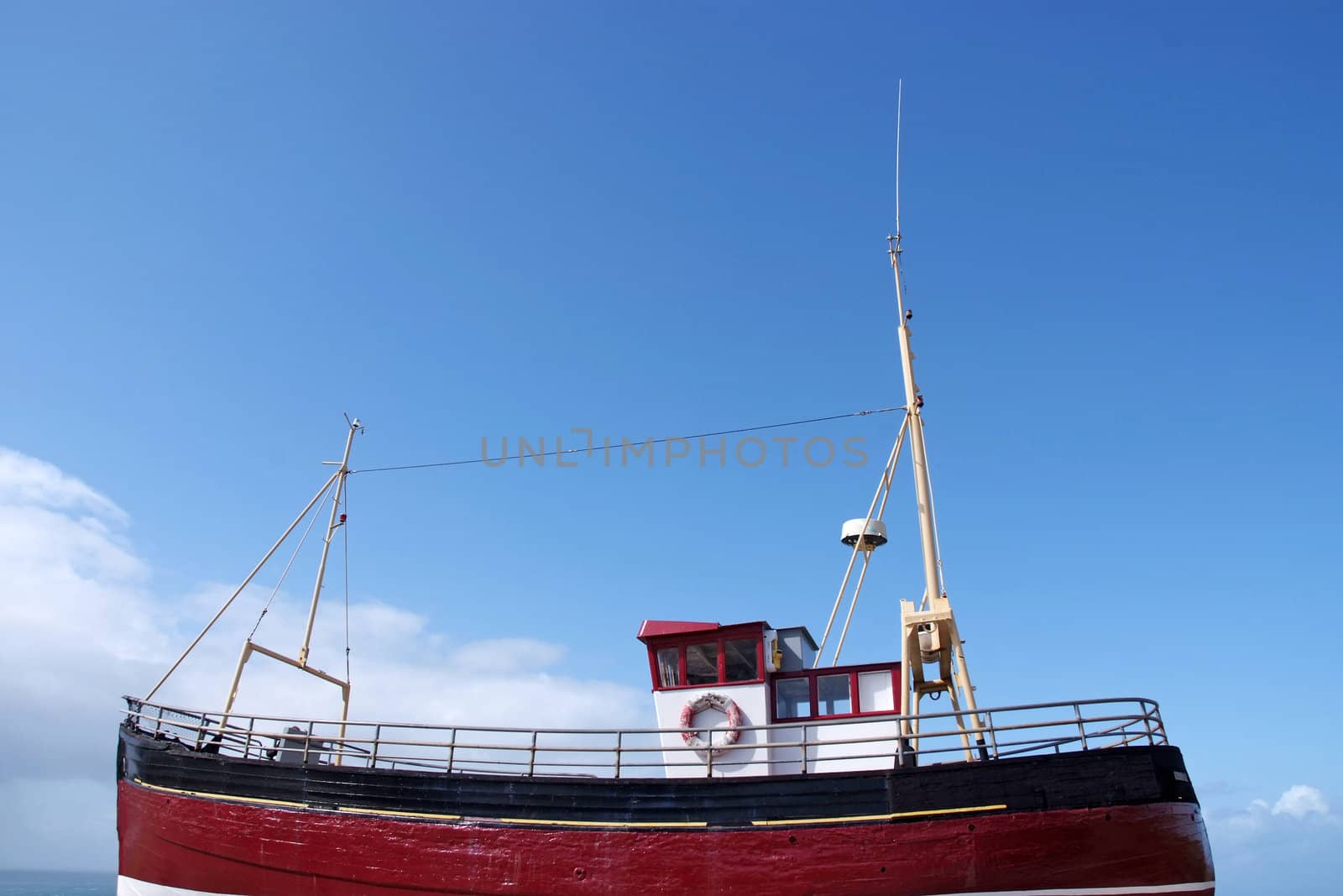 A bright red fishing boat at sea