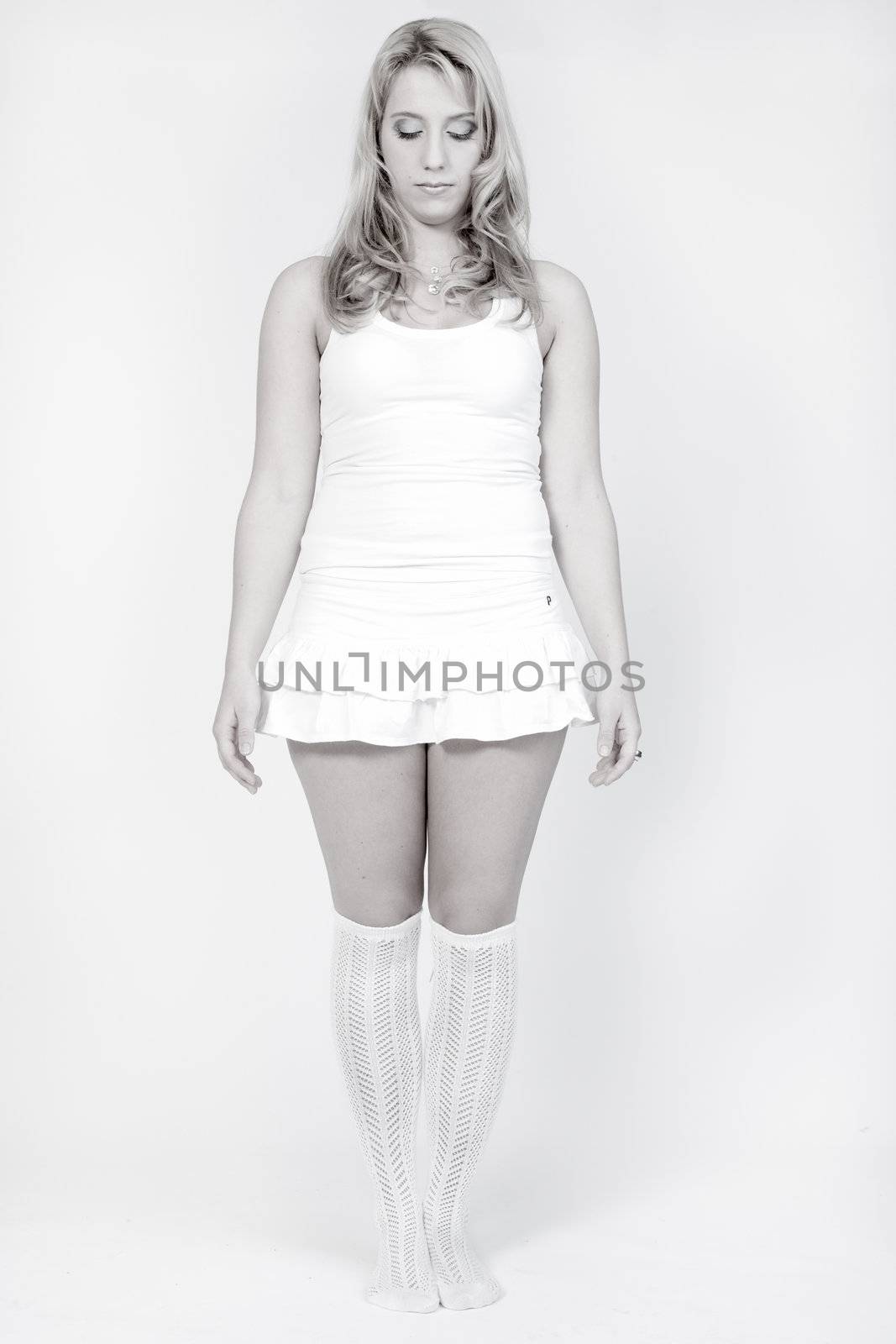 Studio portrait of a long blond girl standing by DNFStyle