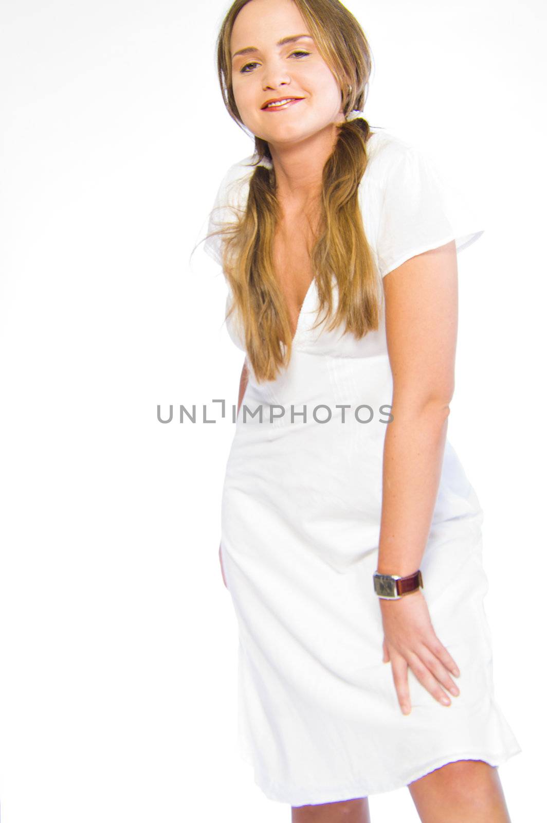 Young caucasian woman in the studio in white burses dress