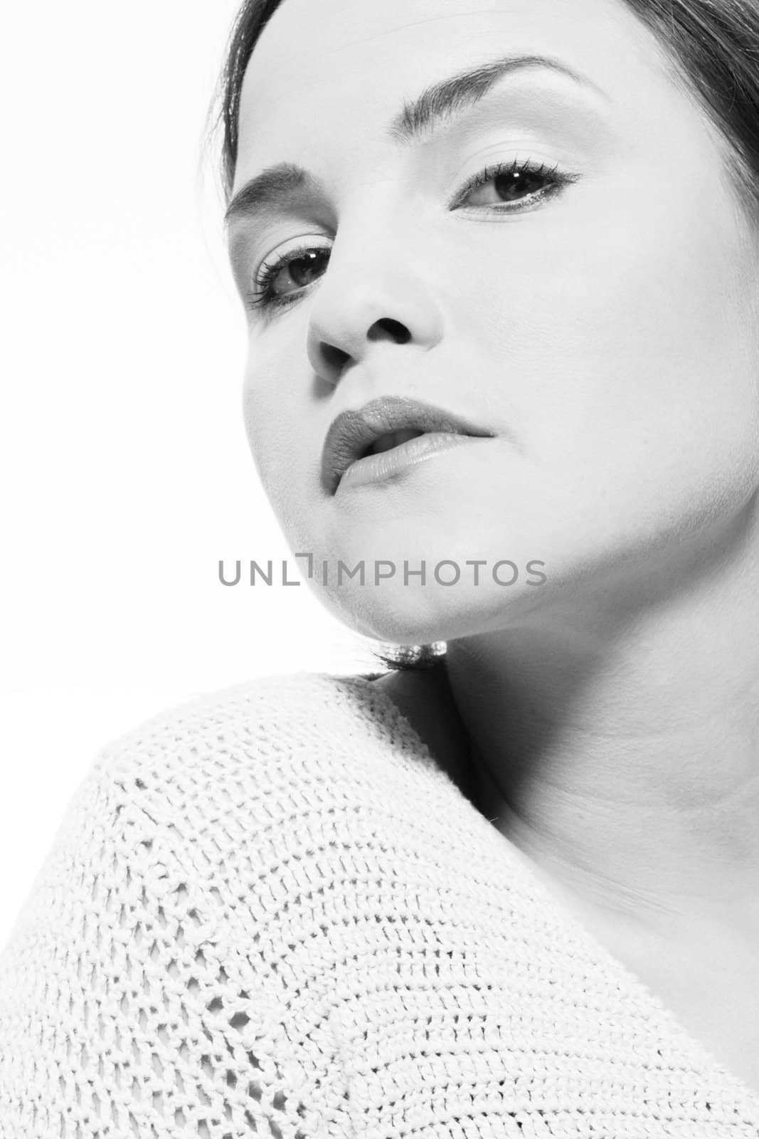 Young caucasian woman in the studio with her chin up and eyes down