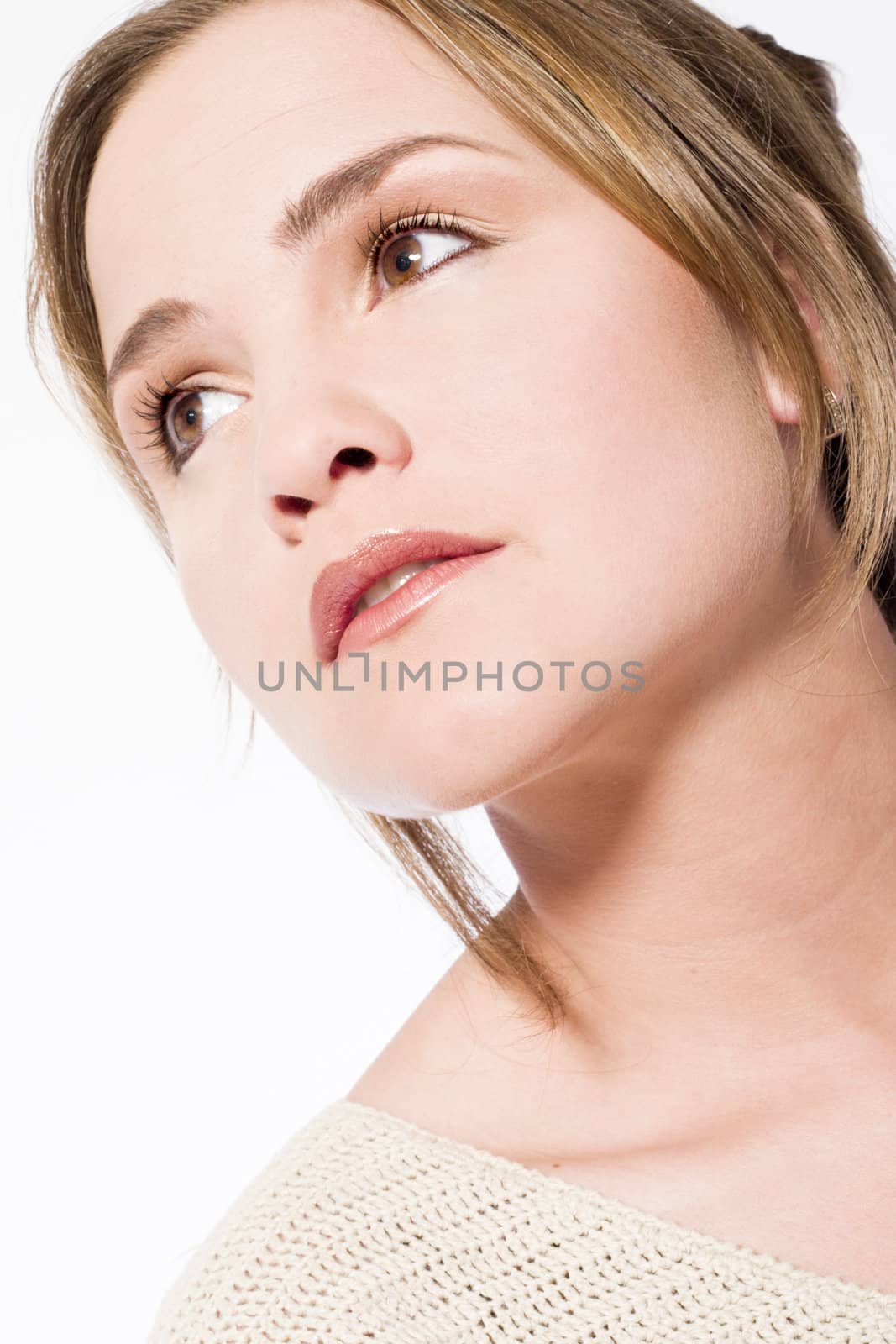 Young caucasian woman in the studio looking up thinking