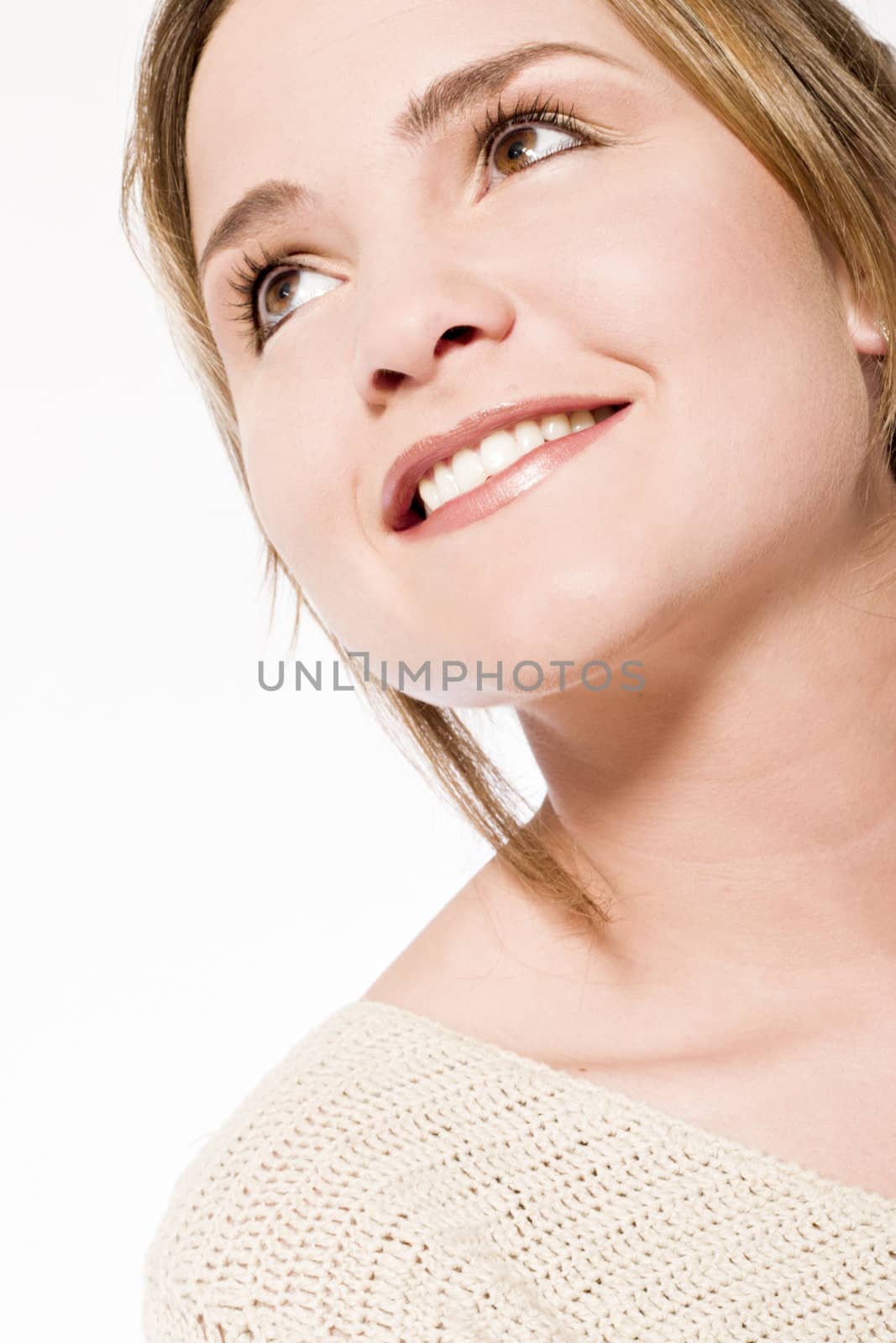 Young caucasian woman in the studio looking up smiling