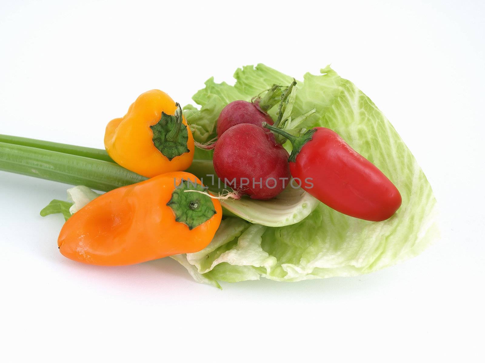 Colorful peppers and greens isolated over a white background.