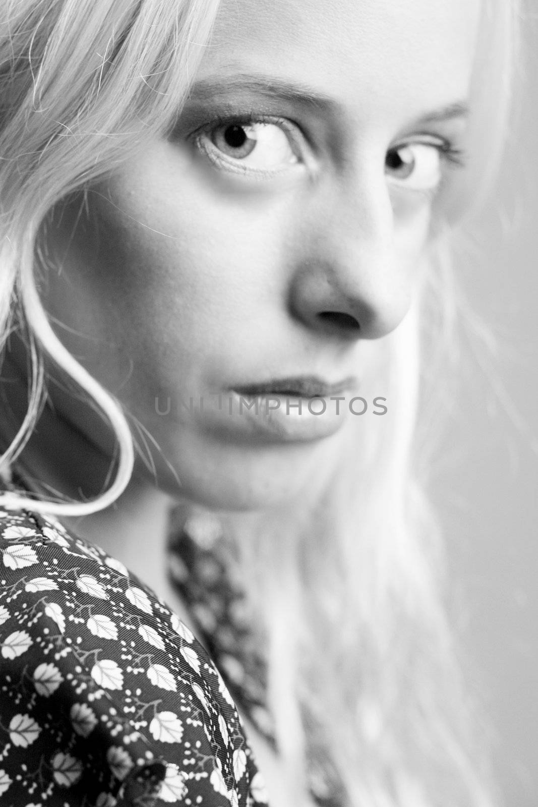 Beautiful blond model in the studio looking disturbed