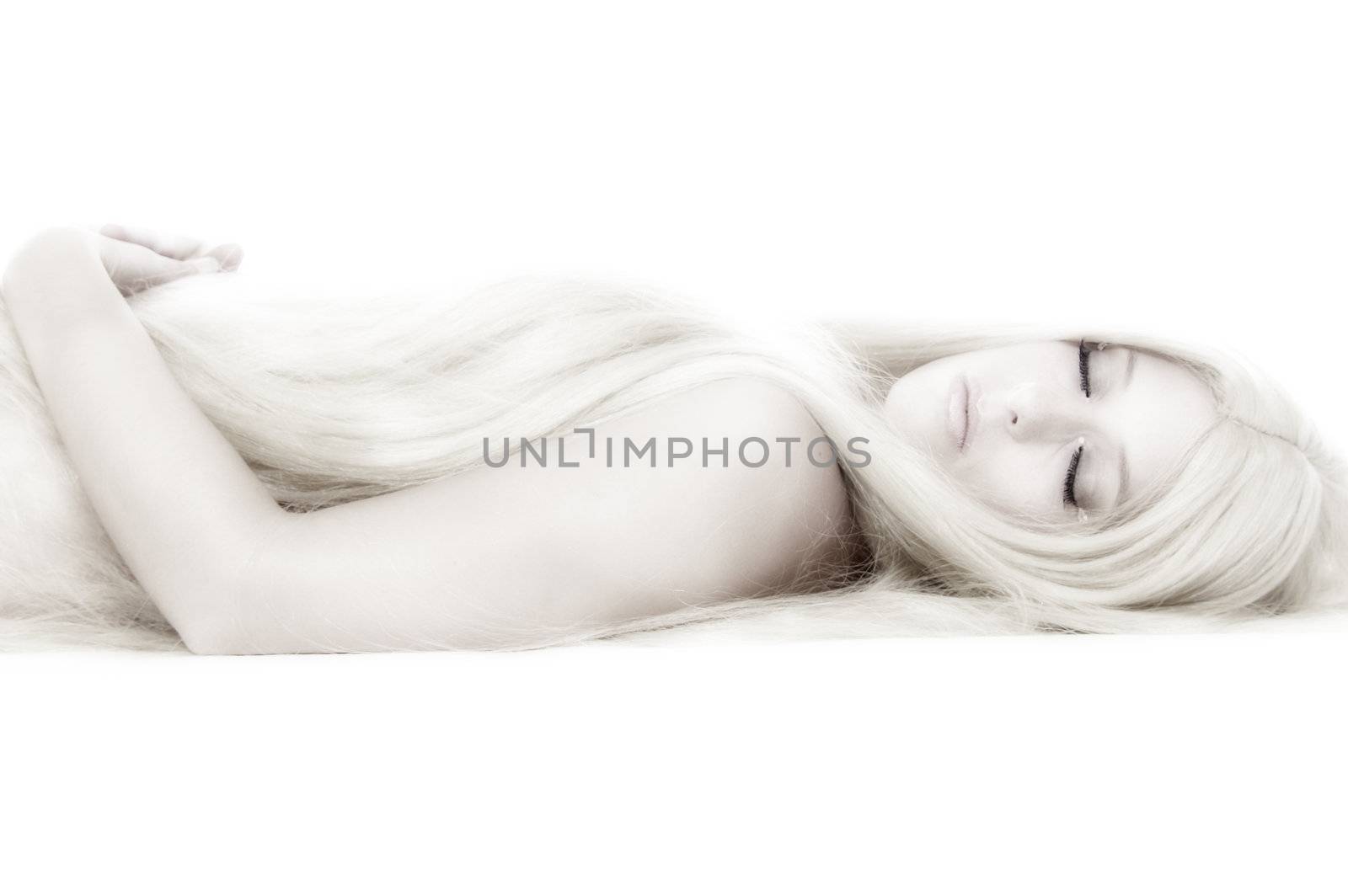 Beautiful blond model in the studio lying down like a princess
