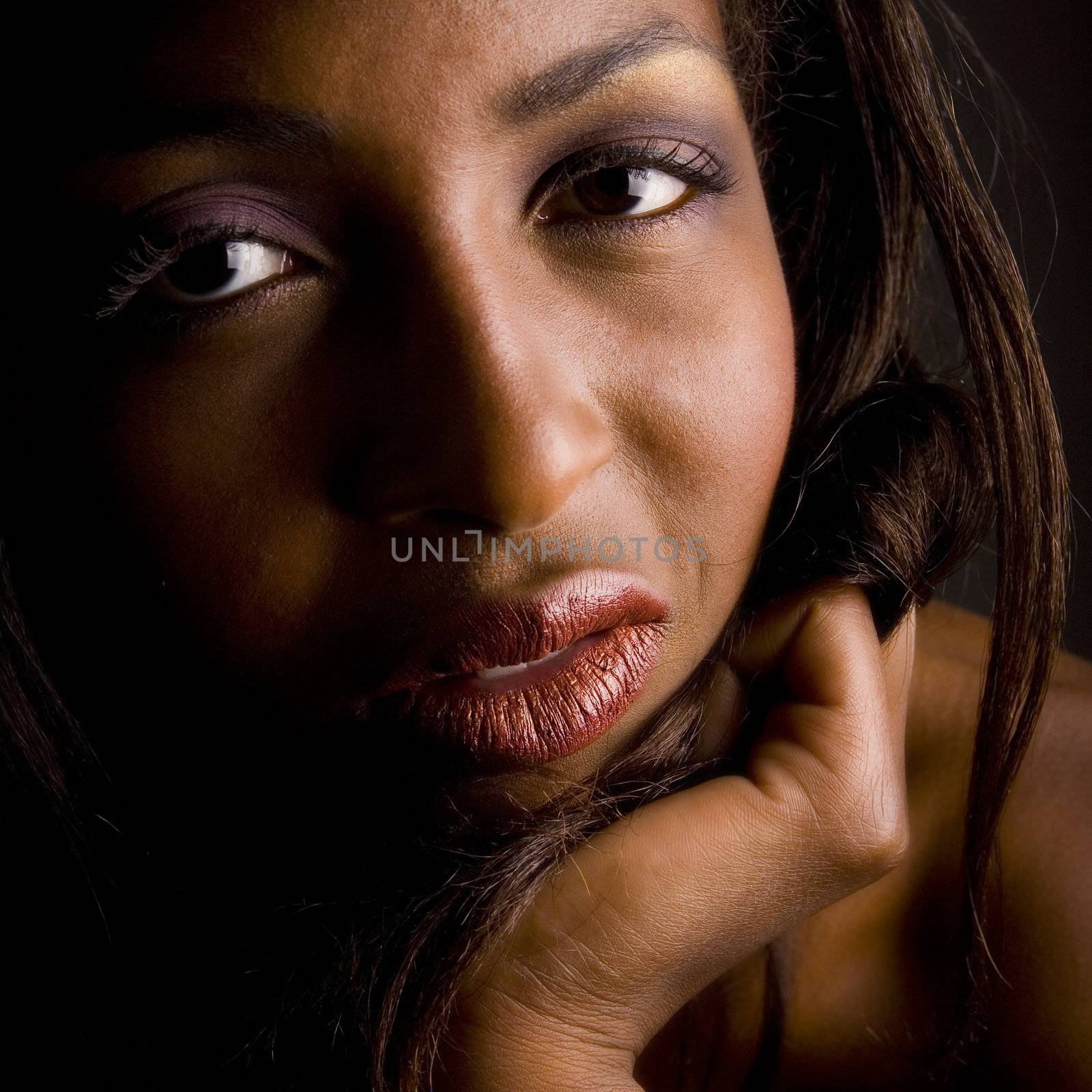 A beauty portrait taken from an african model in the studio looking interested