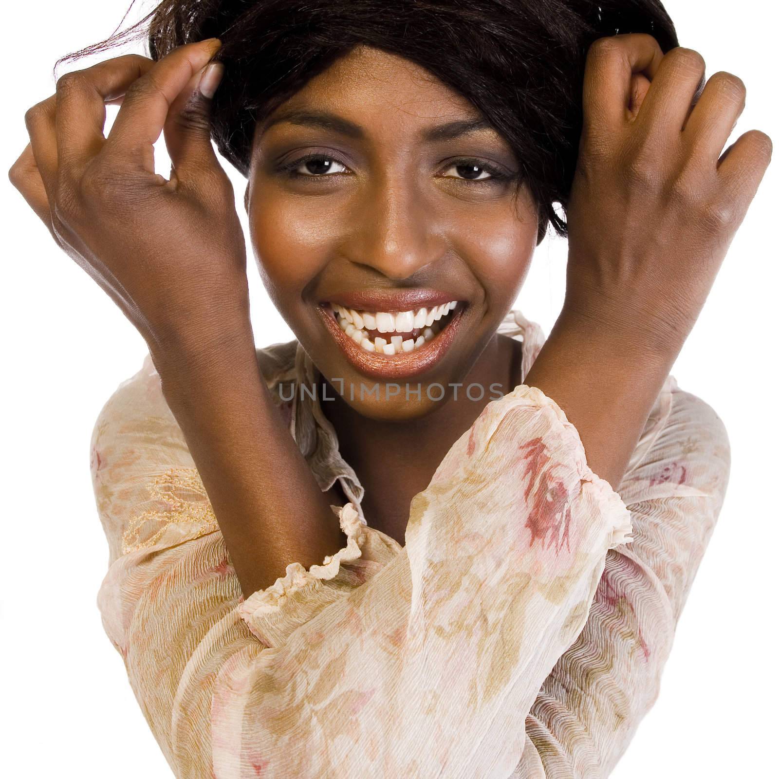 A beauty portrait taken from an african model in the studio fooling with her hair