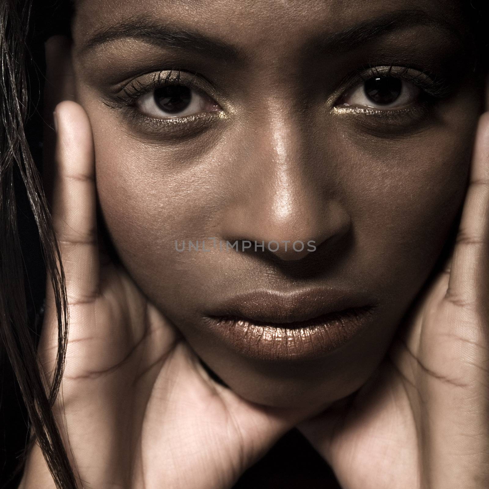 A beauty portrait taken from an african model in the studio looking troubeled