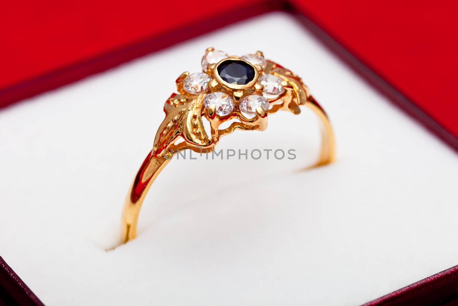 Fantastic gold ring adorned with one blue  and several white zirconia