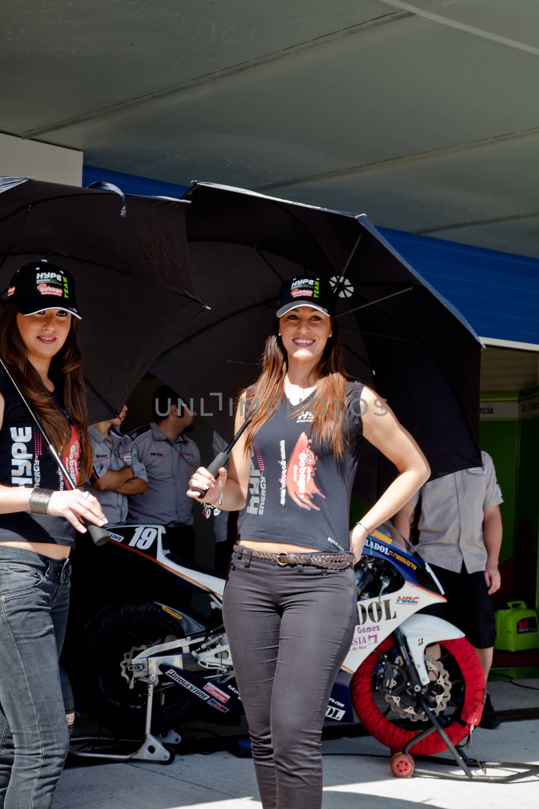 JEREZ DE LA FRONTERA, SPAIN - APR 17:  Unknown pitbabes of team Hype of 125cc of the CEV Championship, posing in the pitlane before begin the race on April 17, 2011, in Jerez de la Frontera , Spain