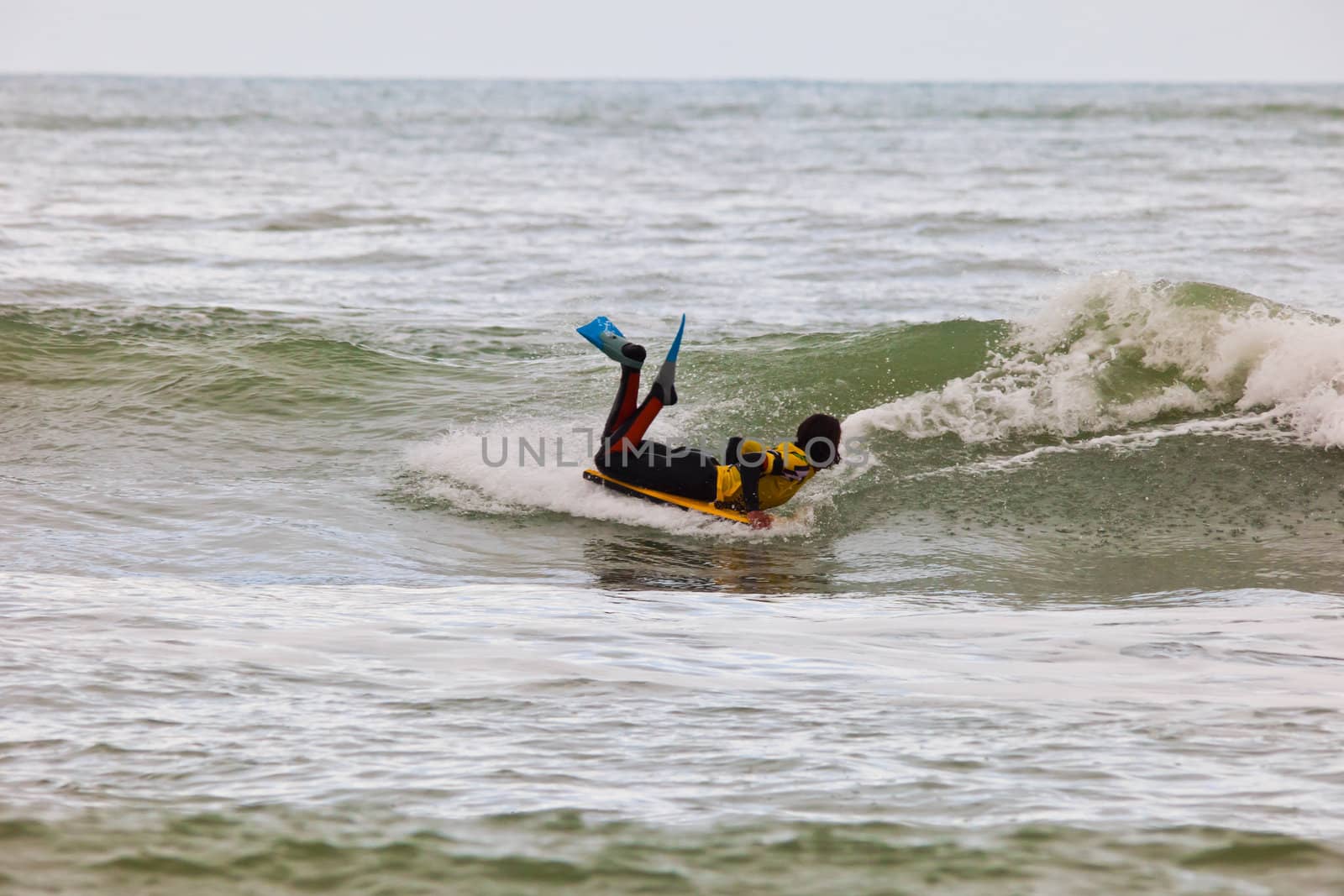 SAN FERNANDO, CADIZ, SPAIN - FEB 19: Unknown bodyboader taking waves on the 2nd championship of Surf and BodyBoard Impoxibol on Feb 19,2011 on the beach of Camposoto of San Fernando, Cadiz, Spain