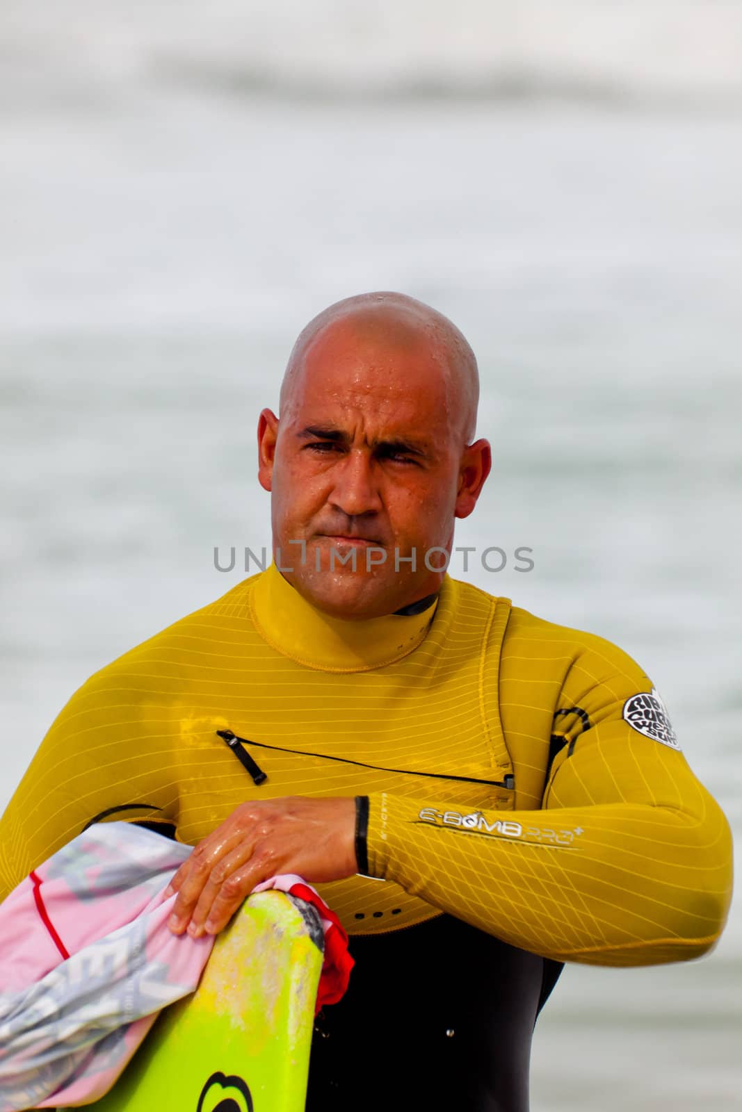 SAN FERNANDO, CADIZ, SPAIN - FEB 19: Unknown bodyboader going to the water on the 2nd championship of Surf and BodyBoard Impoxibol on Feb 19,2011 on the beach of Camposoto of San Fernando, Cadiz, Spain