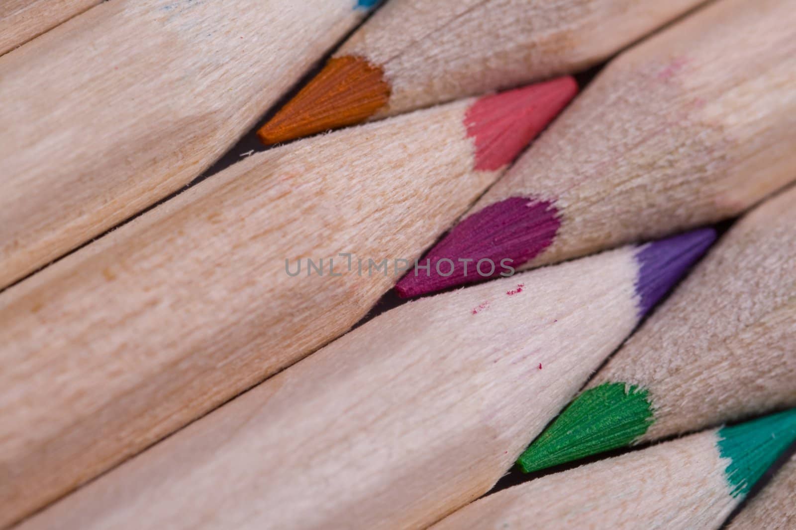 A composition of pencils of wood in a variety of colors