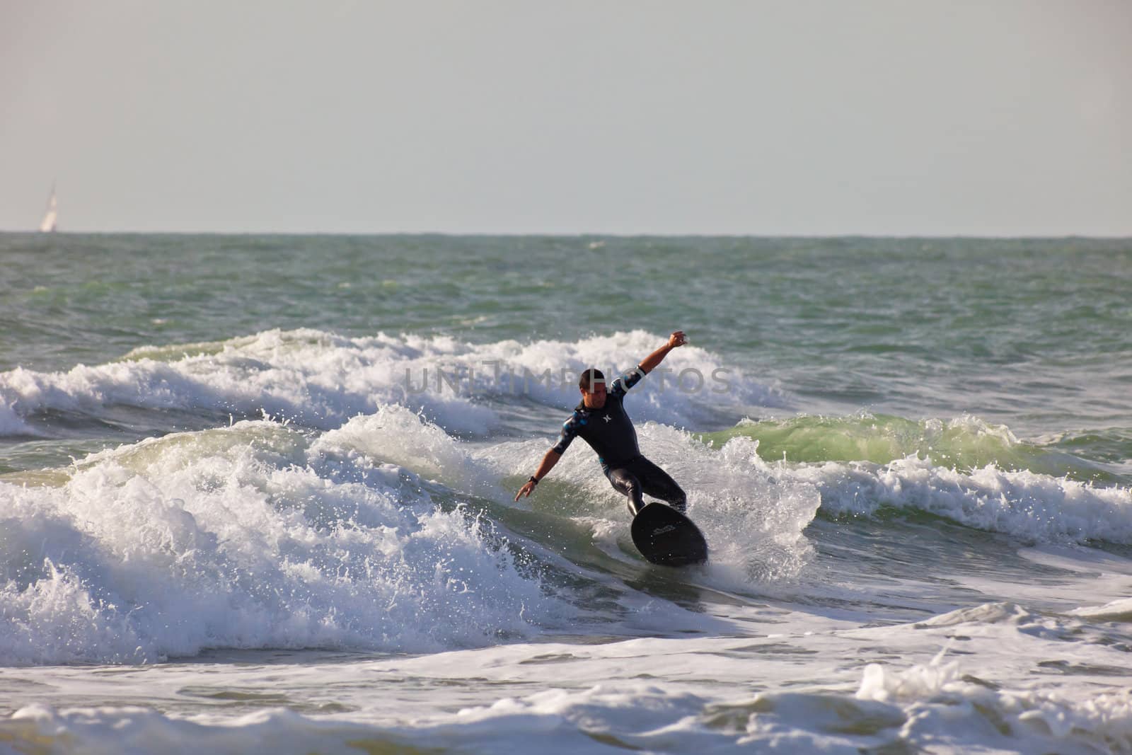 SAN FERNANDO, CADIZ, SPAIN - FEB 19: Unknown surfer taking waves on the 2nd championship of Surf and BodyBoard Impoxibol on Feb 19,2011 on the beach of Camposoto of San Fernando, Cadiz, Spain