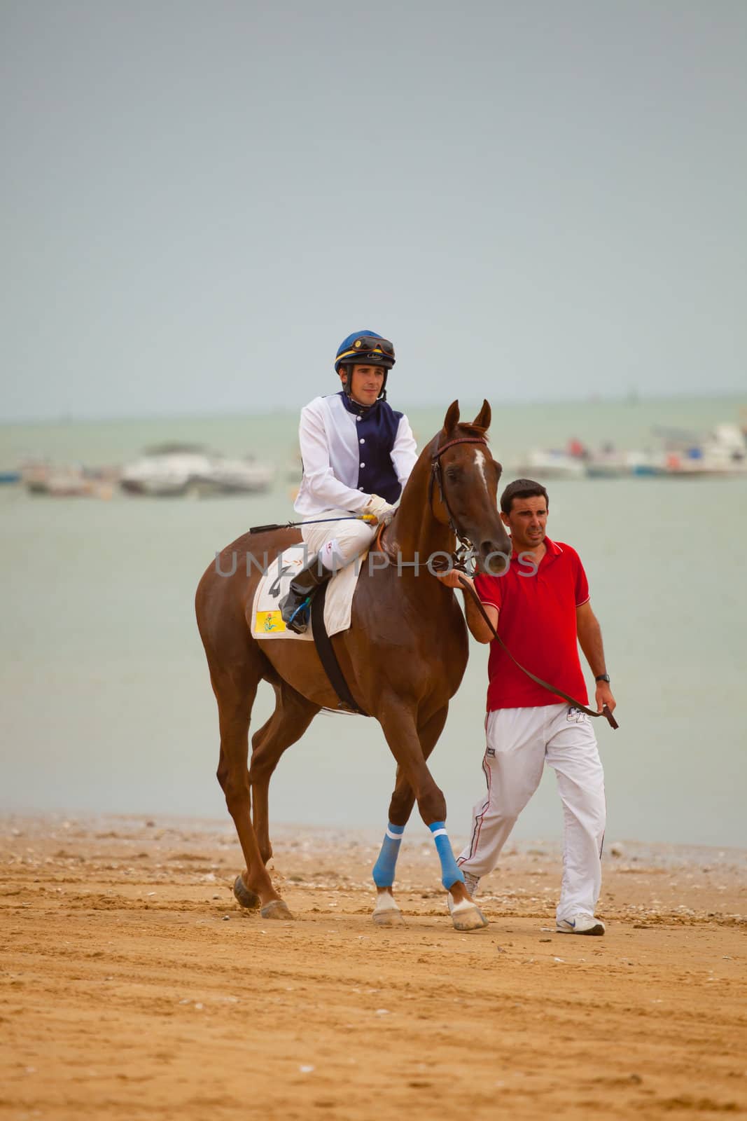 SANLUCAR DE BARRAMEDA, CADIZ, SPAIN - AUGUST 07: Unknown rider at the start of the horses races of the beach of Sanlucar de Barrameda on August 07, 2010 in Sanlucar de Barrameda, Cadiz, Spain.