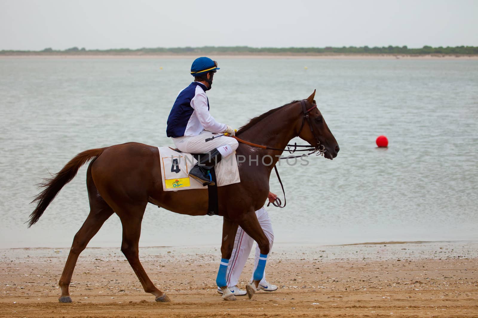 SANLUCAR DE BARRAMEDA, CADIZ, SPAIN - AUGUST 07: Unknown rider at the start of the horses races of the beach of Sanlucar de Barrameda on August 07, 2010 in Sanlucar de Barrameda, Cadiz, Spain.