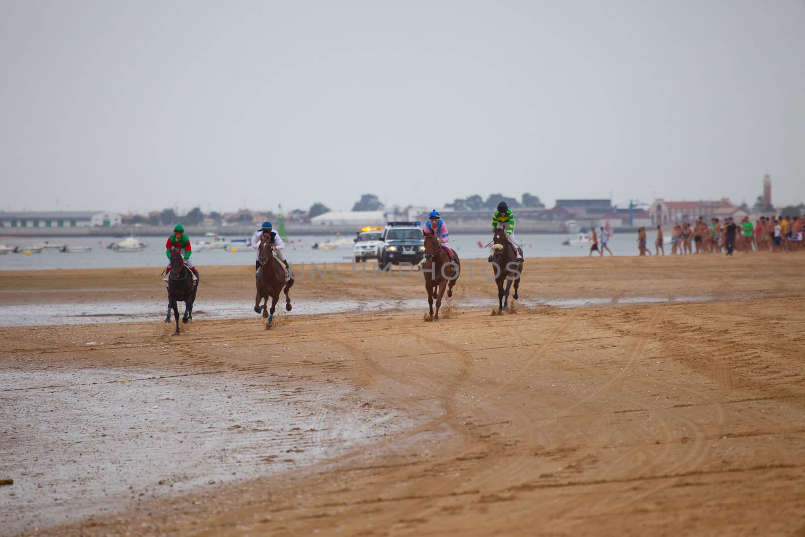 SANLUCAR DE BARRAMEDA, CADIZ, SPAIN - AUGUST 07: Unknown riders of the horses races of the beach of Sanlucar de Barrameda on August 07, 2010 in Sanlucar de Barrameda, Cadiz, Spain.
