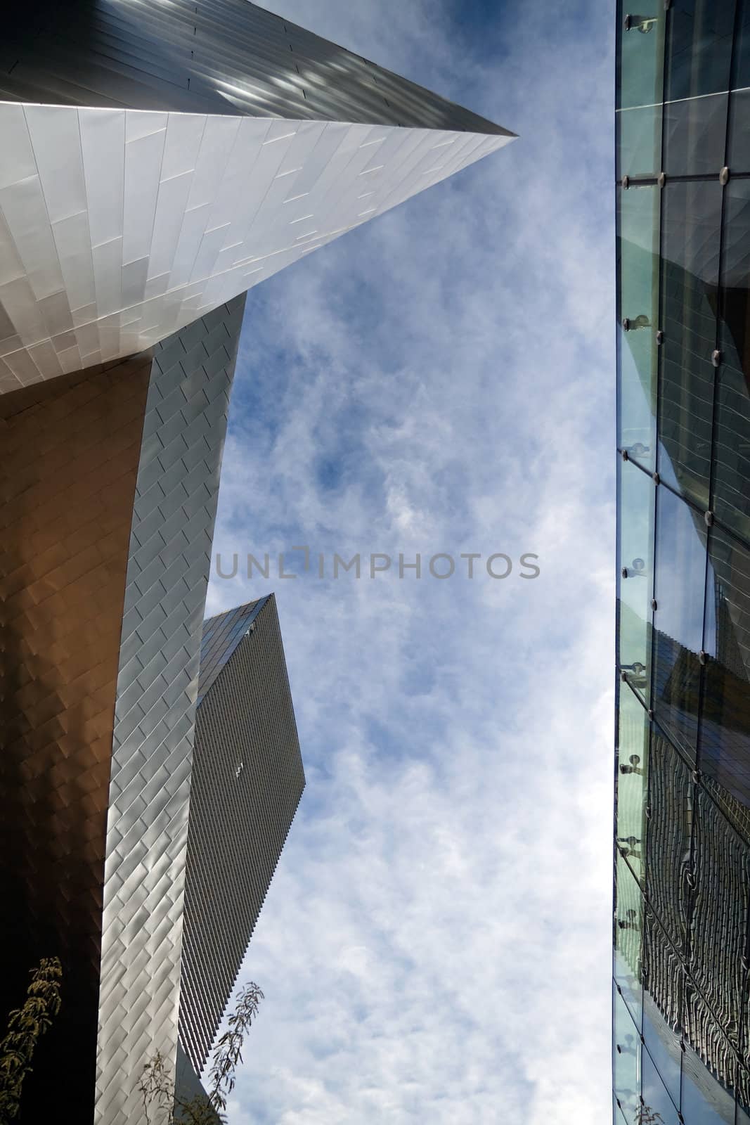 A view of the sky between two modern buildings 
