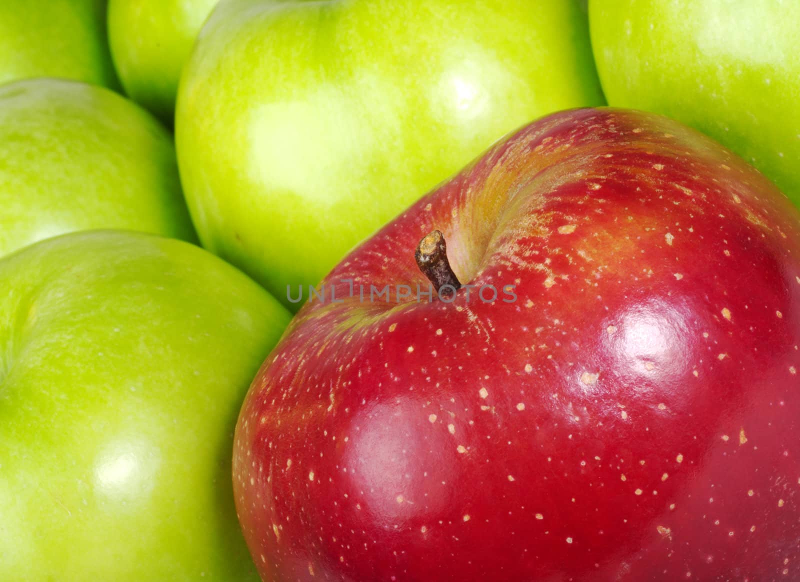 Red colored Apple in between many green Apples (Selective Focus, Close-Up, tilted)