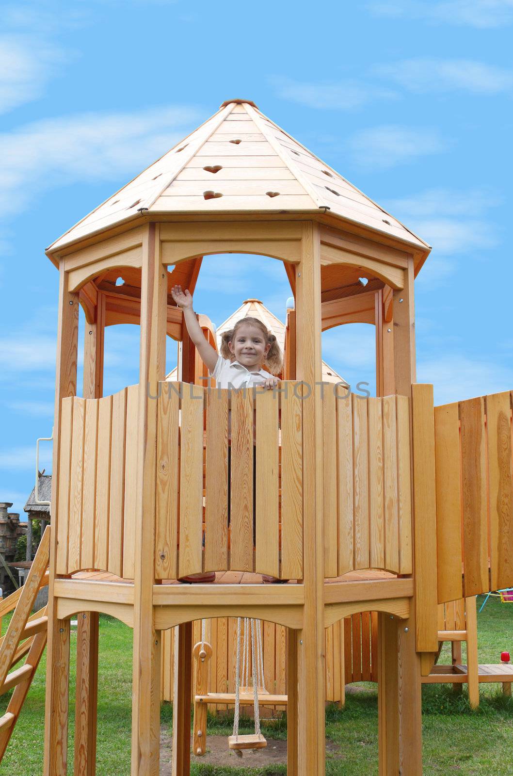 little girl standing in playground tower by goce
