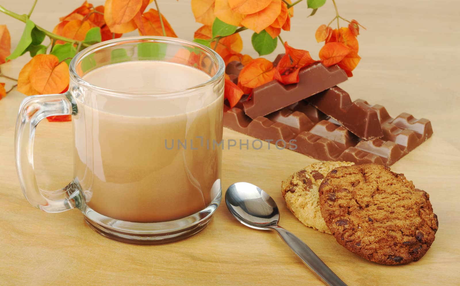 Hot Chocolate in Glass with Chocolate Chip Cookies and Chocolate Bar on wooden board (Selective Focus)