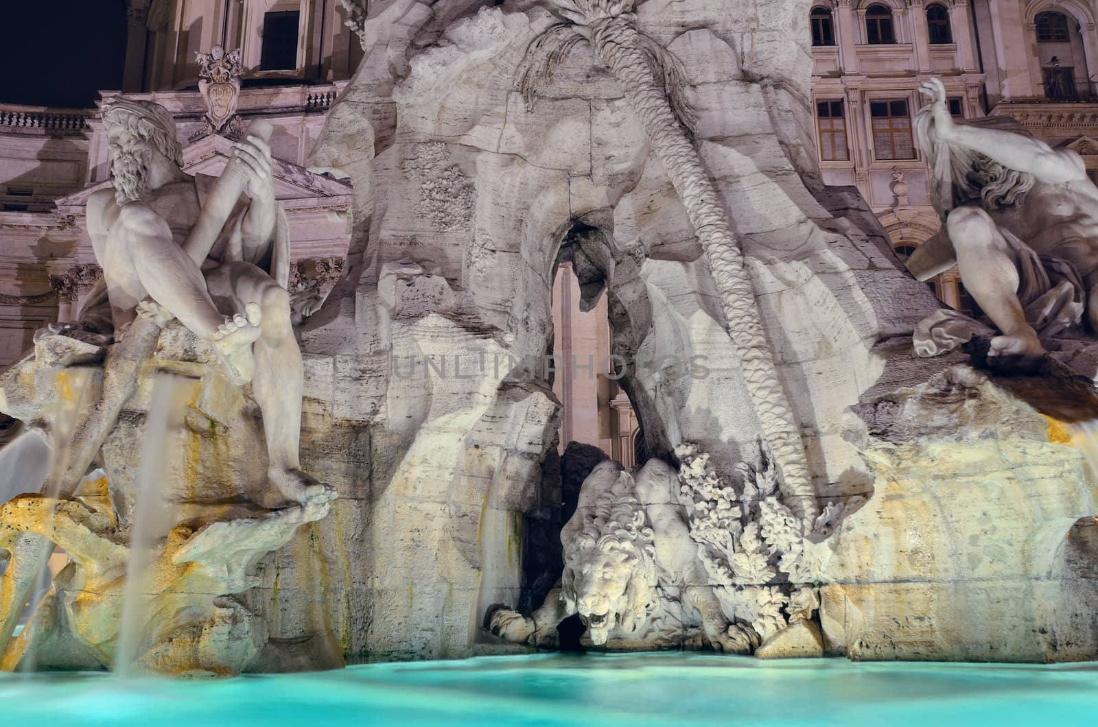 Fountain of the Four Rivers illuminated at night. Rome, Italy