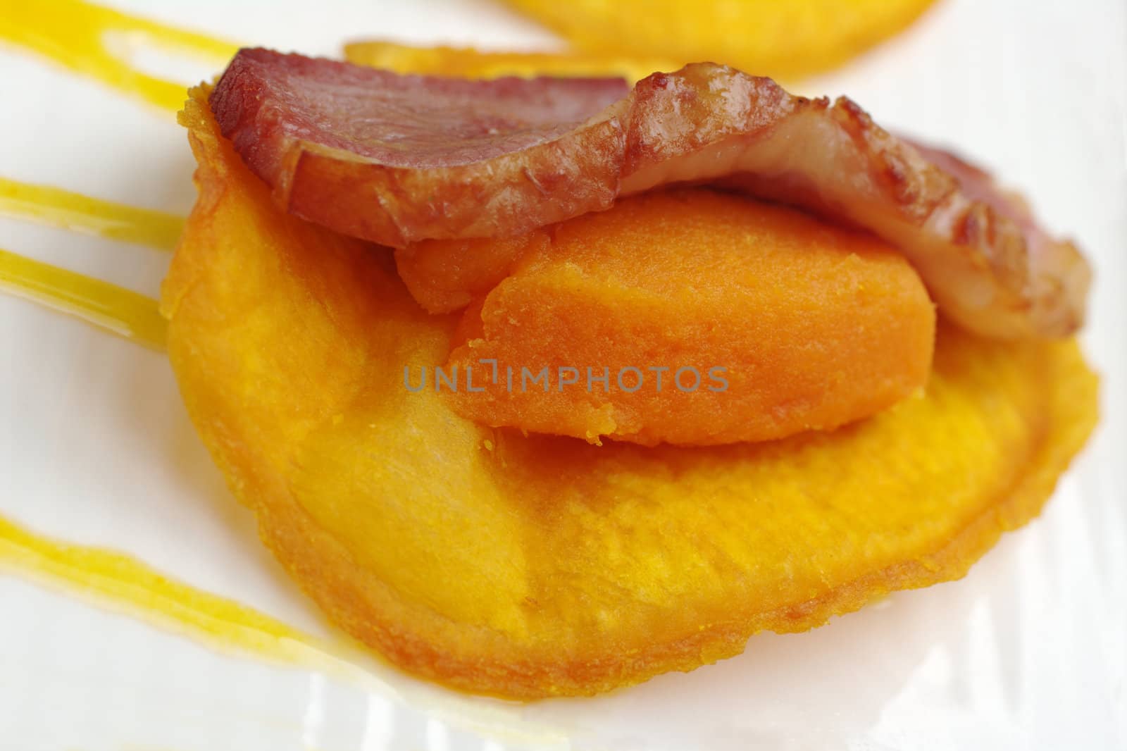 Appetizer: A slice of ham on mashed sweet potato and sweet potato chip (Very Shallow Depth of Field) 