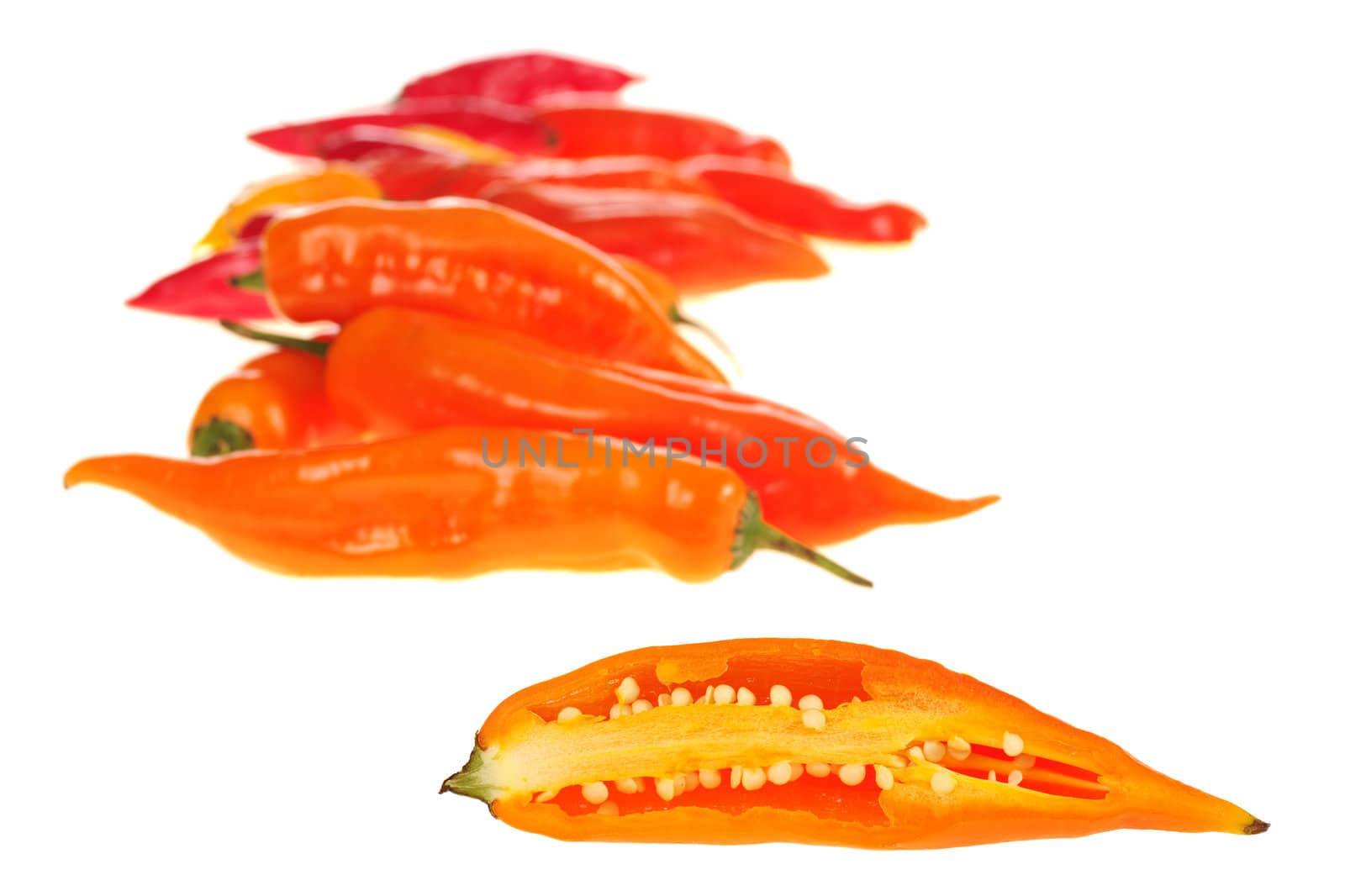 Peruvian hot pepper: An aji cut half with other ajis in the background isolated on white (Selective Focus)