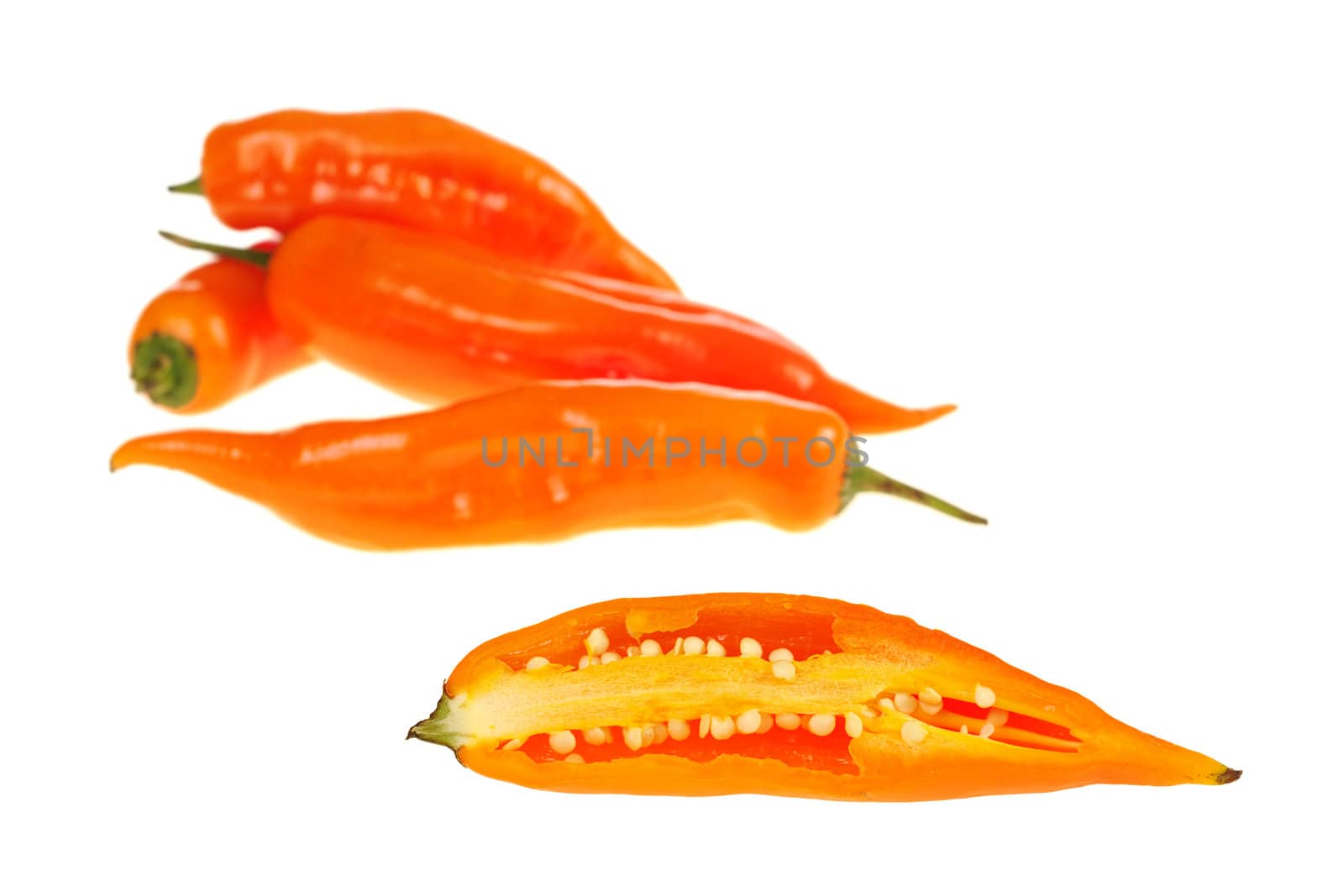 Peruvian hot pepper: An aji cut half with other ajis in the background isolated on white (Selective Focus)