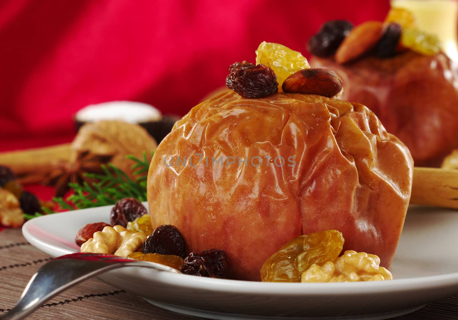 Baked apple with walnuts, raisins and almonds and fork (Selective Focus) 