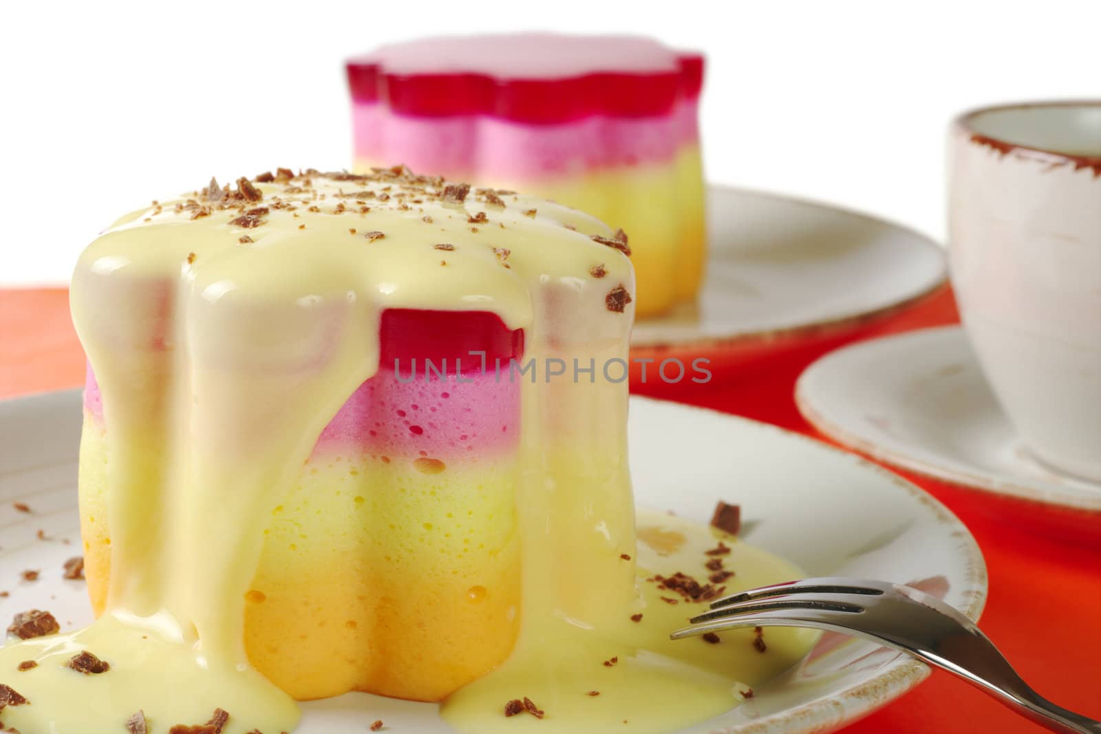 Peruvian colorful small cakes called Torta Helada in the shape of a flower with vanilla custard, chocolate shavings and coffee (Selective Focus) 