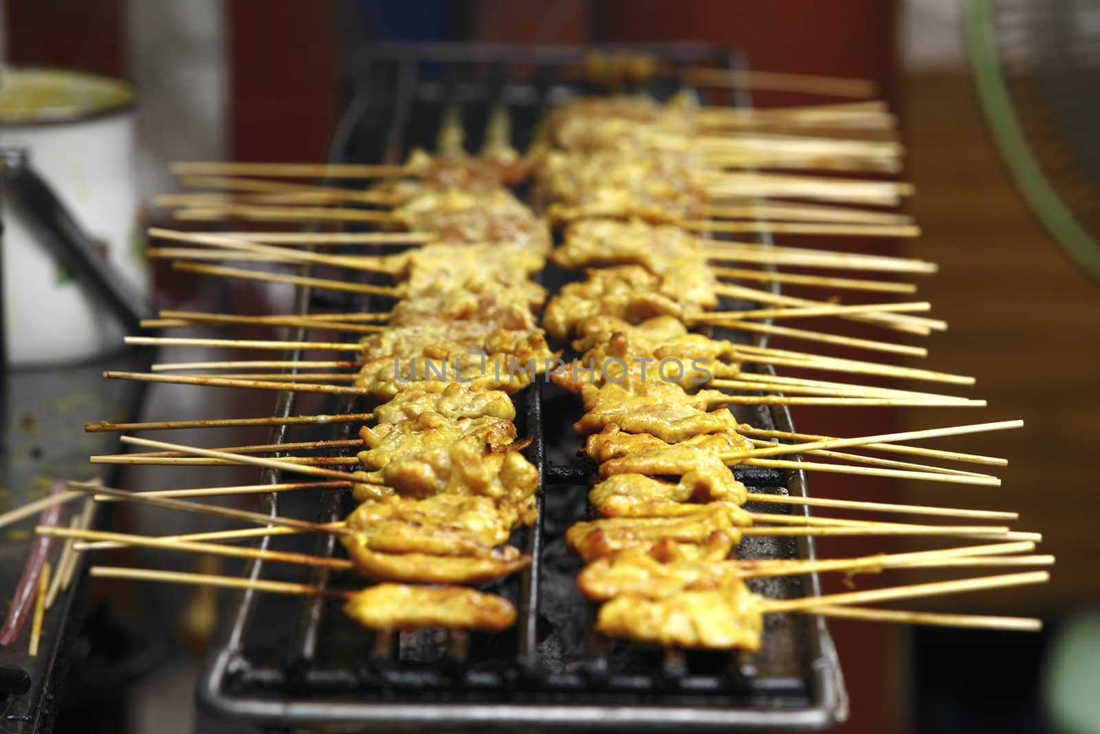 Barbecue Pork spare ribs cooking on a grill outdoors in summer