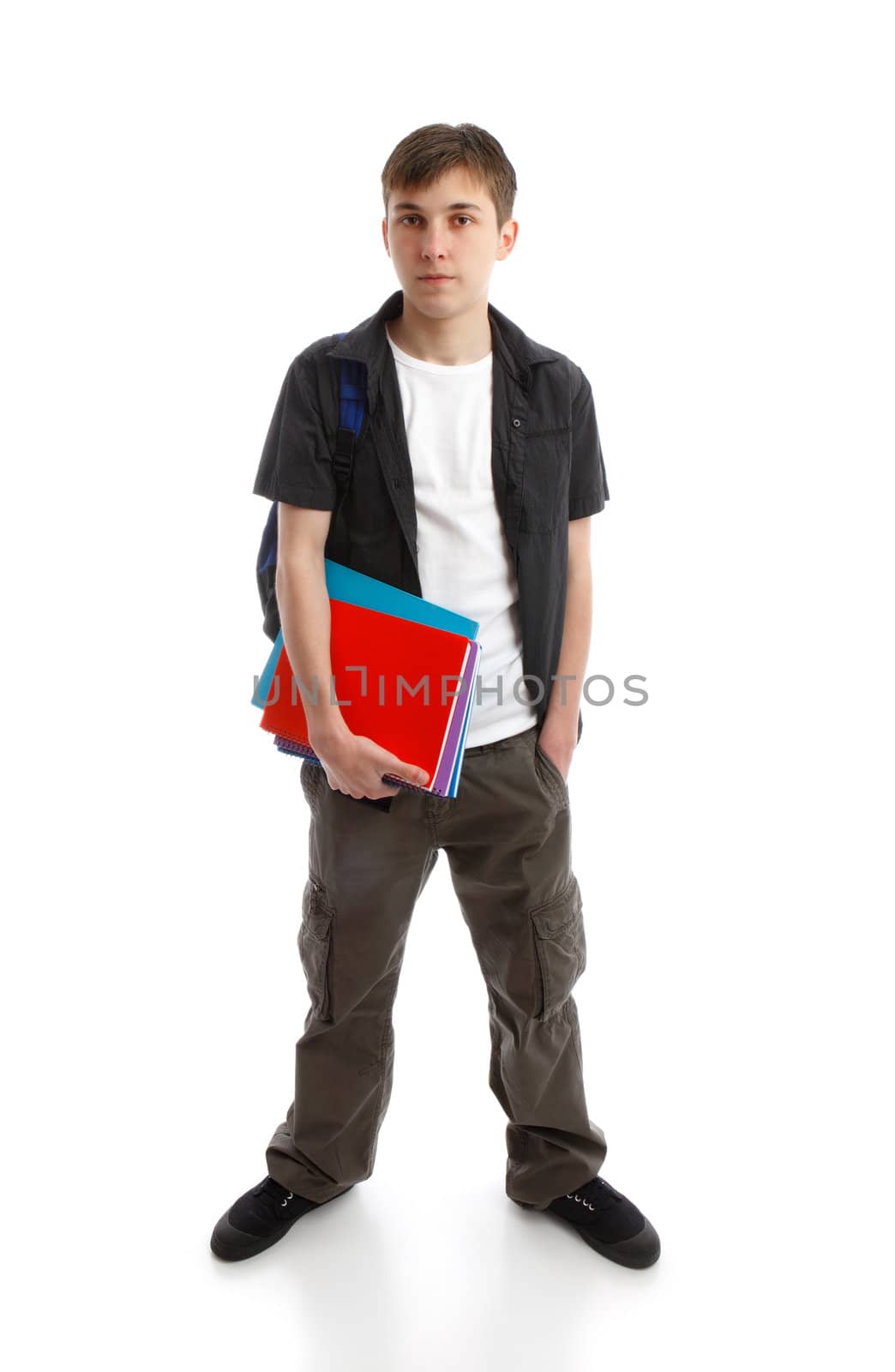 A teenage student standing with hand in pocket.  He is carrying a backpack and some books.  White background.