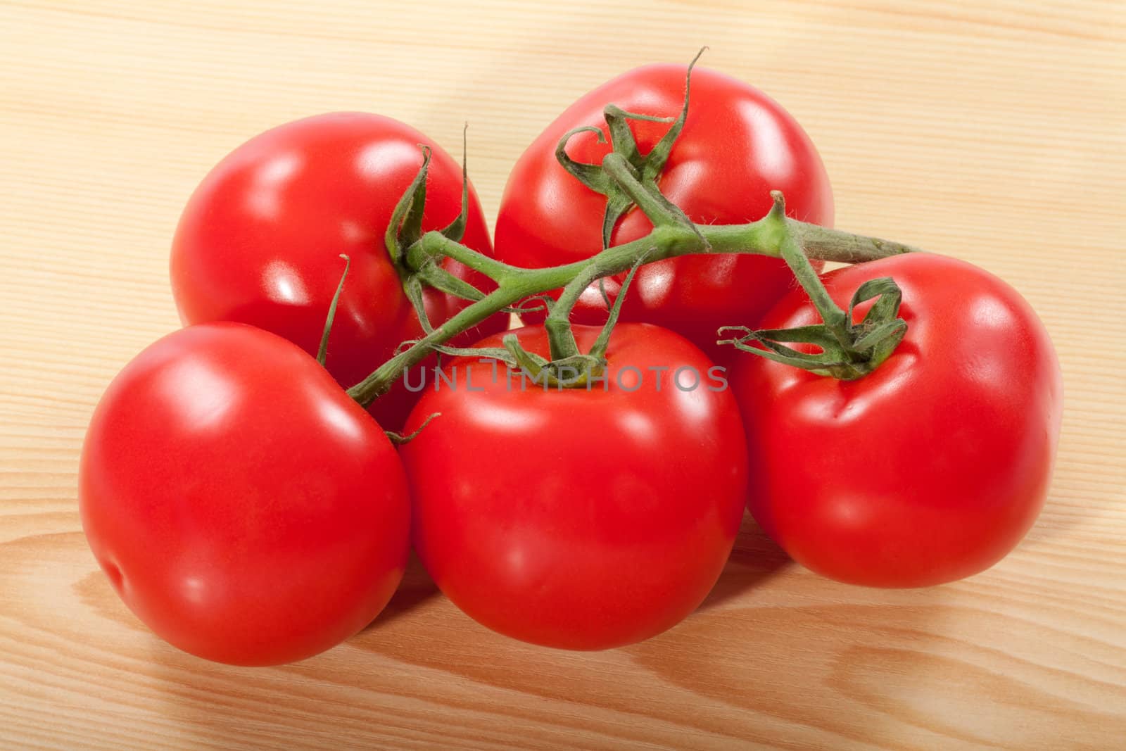 fresh red tomatoes on a wooden table