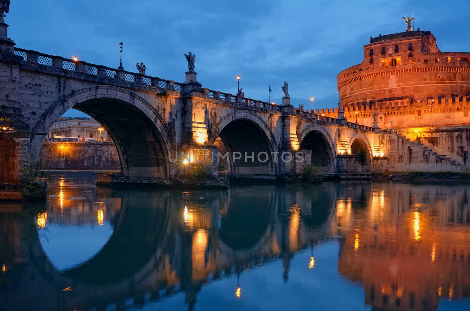 Bridge crossing the river Tiber and Castel Sant'Angelo illuminated at night