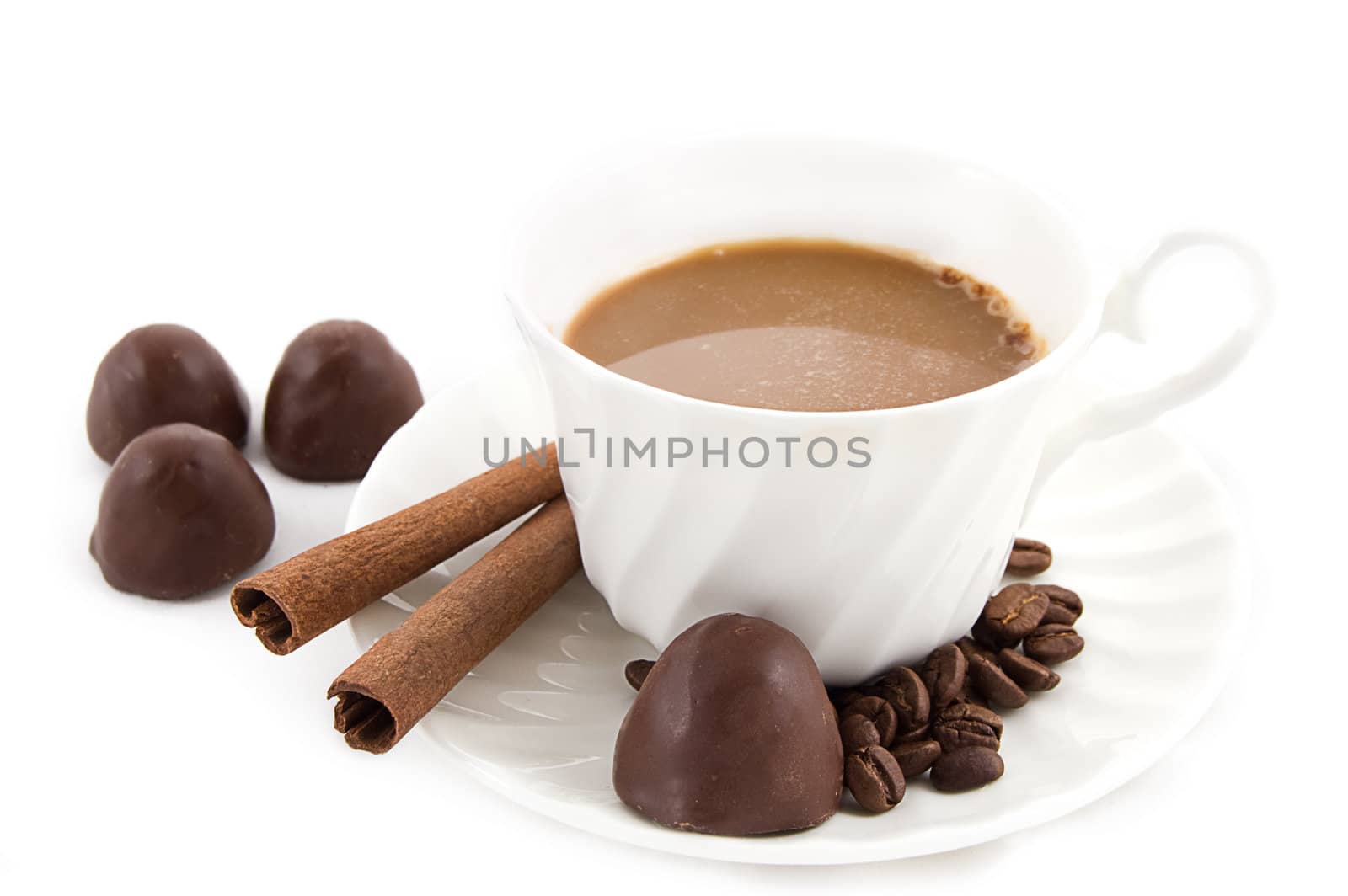 Cappuccino with coffee beans and chocolate over white