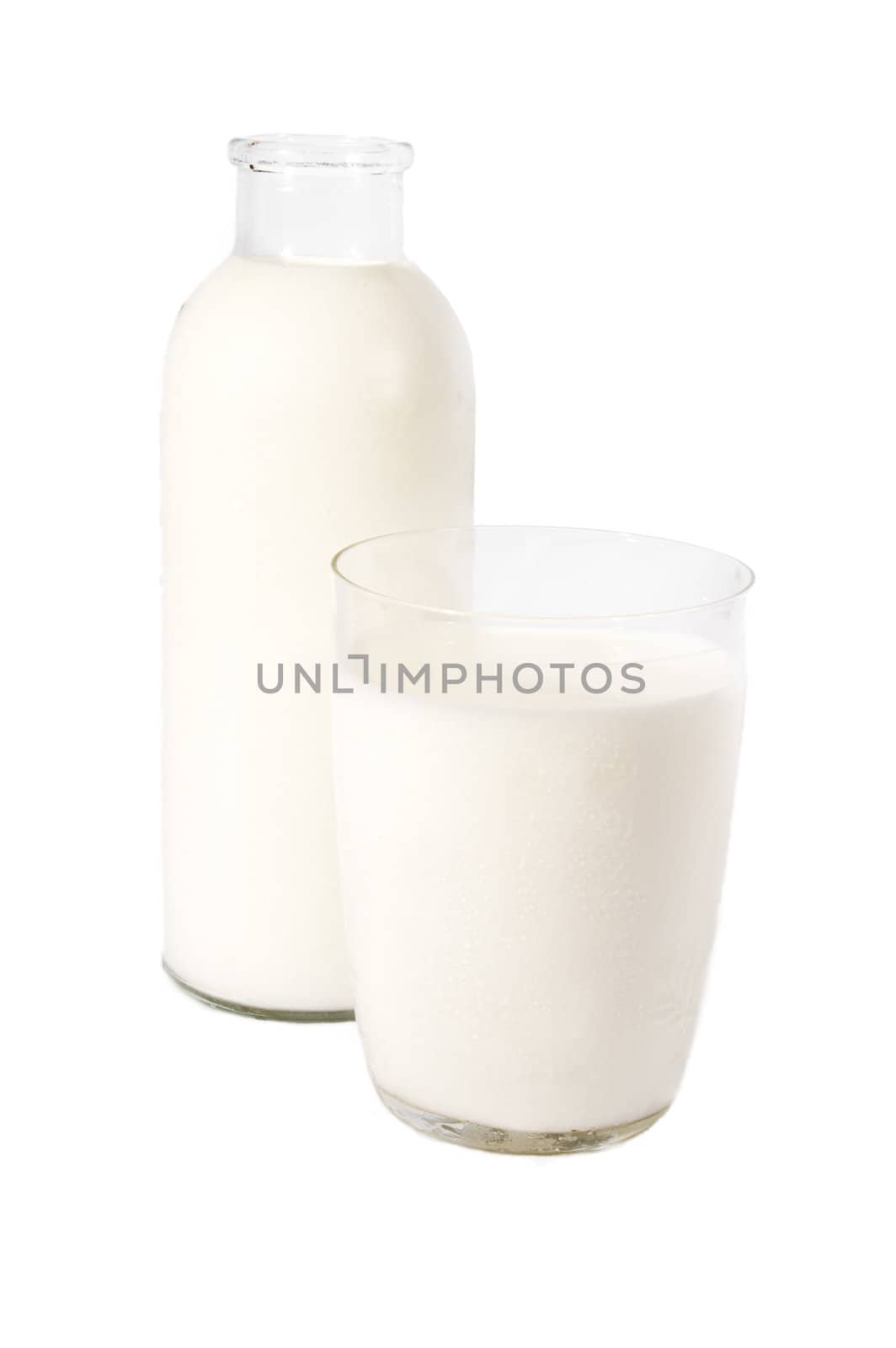 Bottle and glass of milk over white