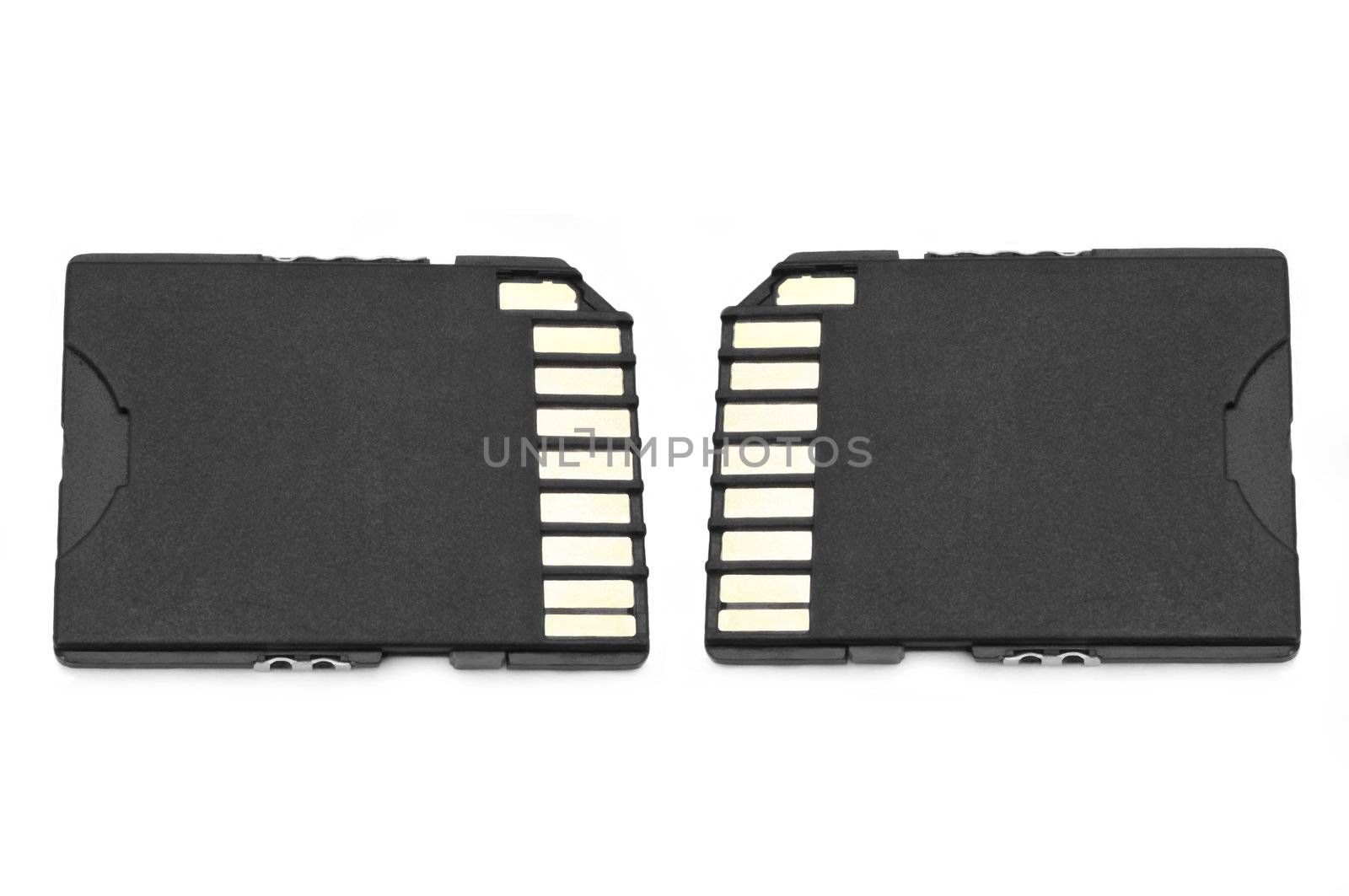 Close up on two black SD memory cards arranged over white