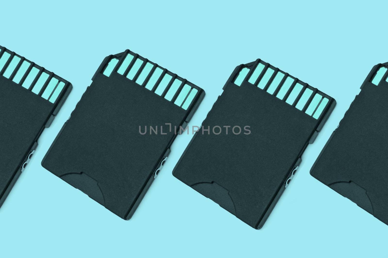 Close up on a row of black SD memory cards arranged with light blue filter