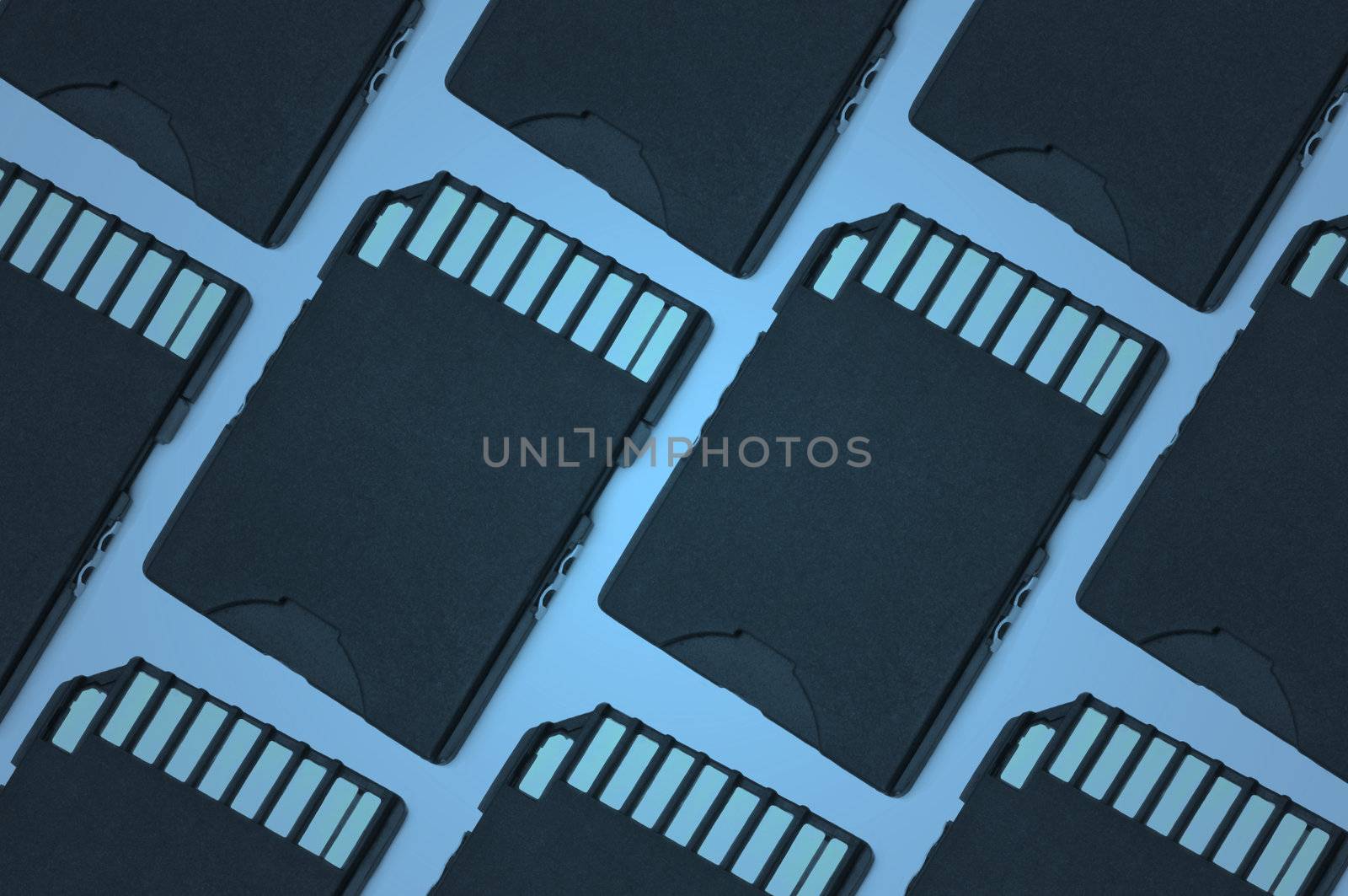 Close up on a pattern of black SD memory cards arranged with blue filter