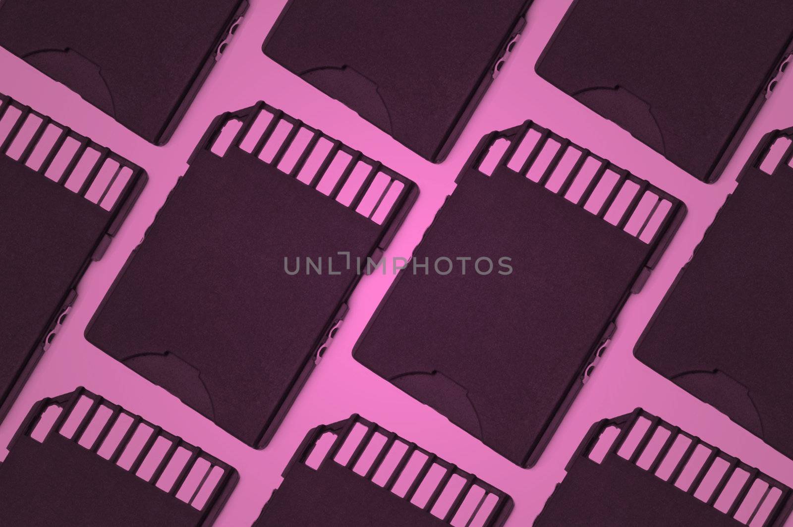Close up on several sd cards arranged in a parallel pattern with pink filter