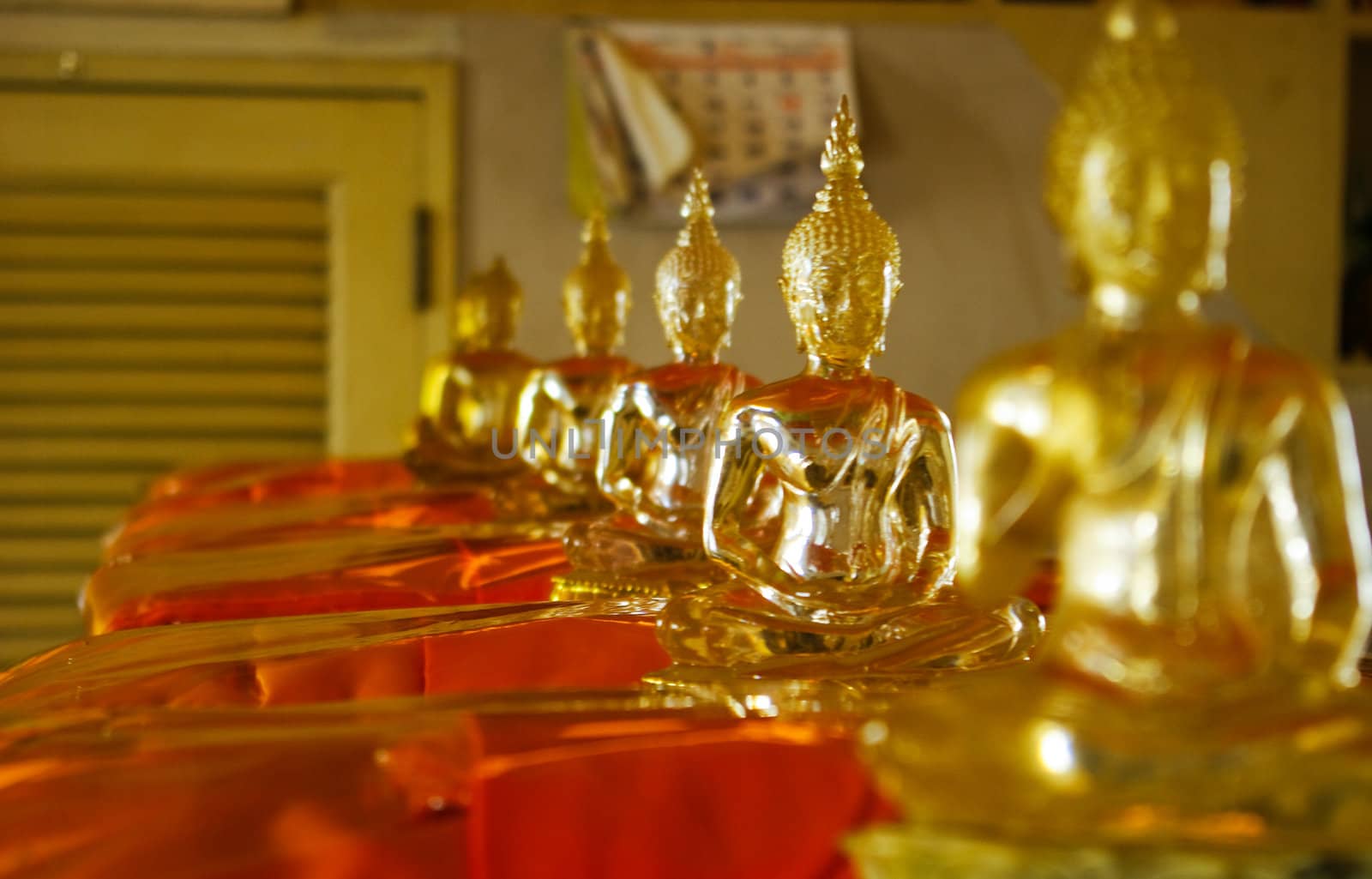 Golden Buddhist idol in the temple by pixbox77