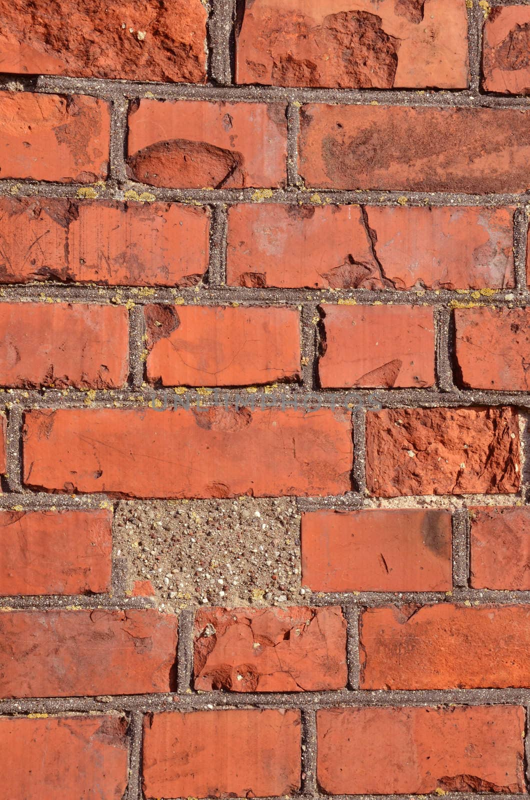 Fragment of old squared red brick wall.