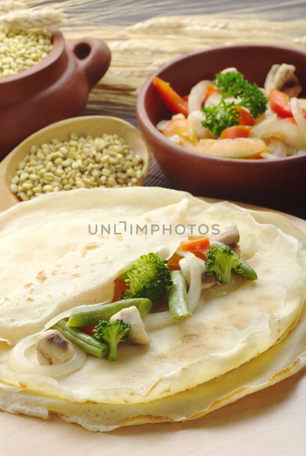 Broccoli, mushrooms, beans, onions and pepper on pancakes with ingredients in the background (Selective Focus, Focus on the broccoli, bean and mushroom in the front)