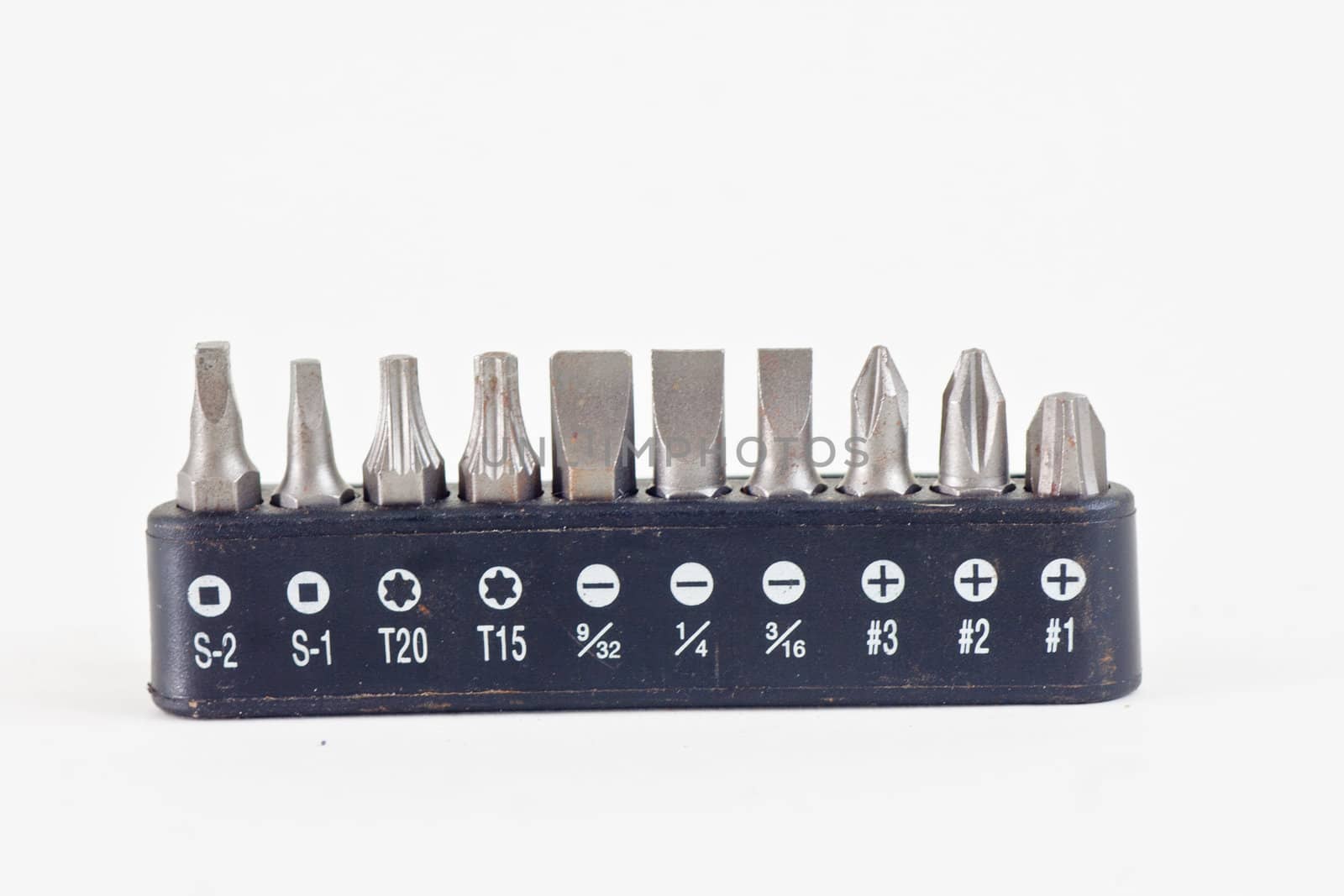 Multiple sizes and shapes of bits for a electric drill on a white background.