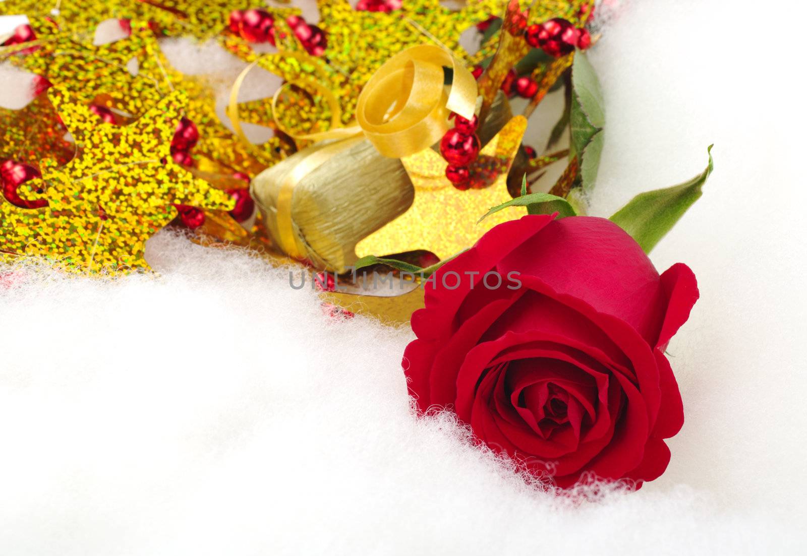 Red rose and golden present with Christmas decoration on cotton (Selective Focus, Focus on the rose)