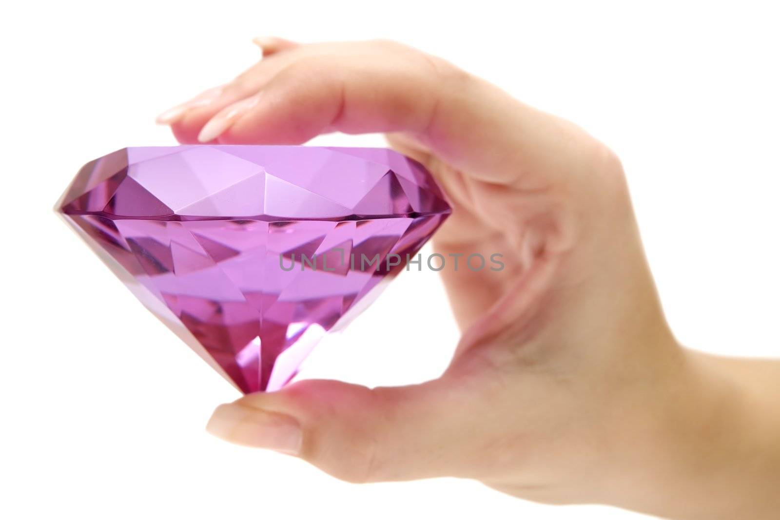 Female hand holding a precious gem. Isolated on a white background.