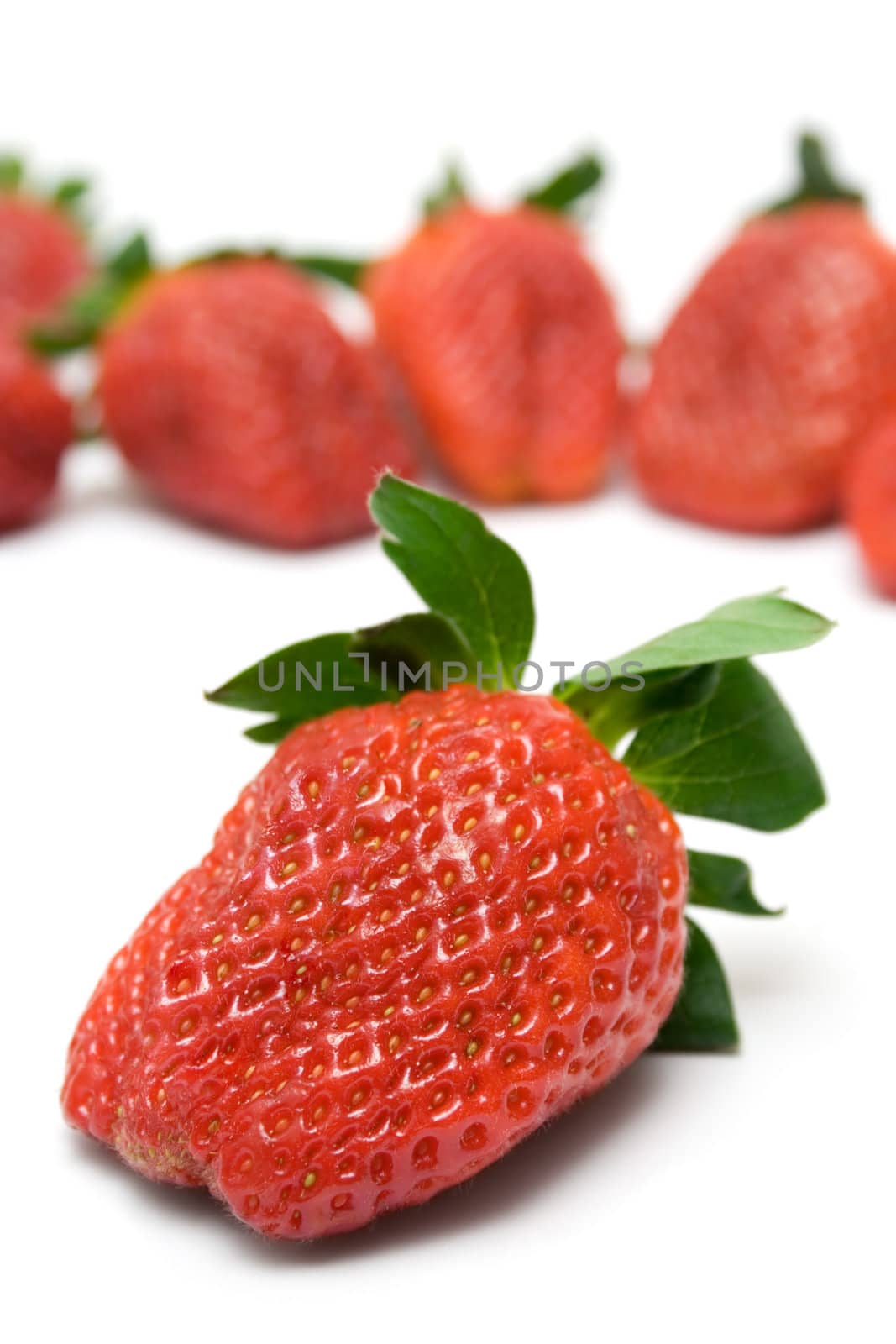 Bunch of Strawberries. Front one focused. Isolated on a white background.