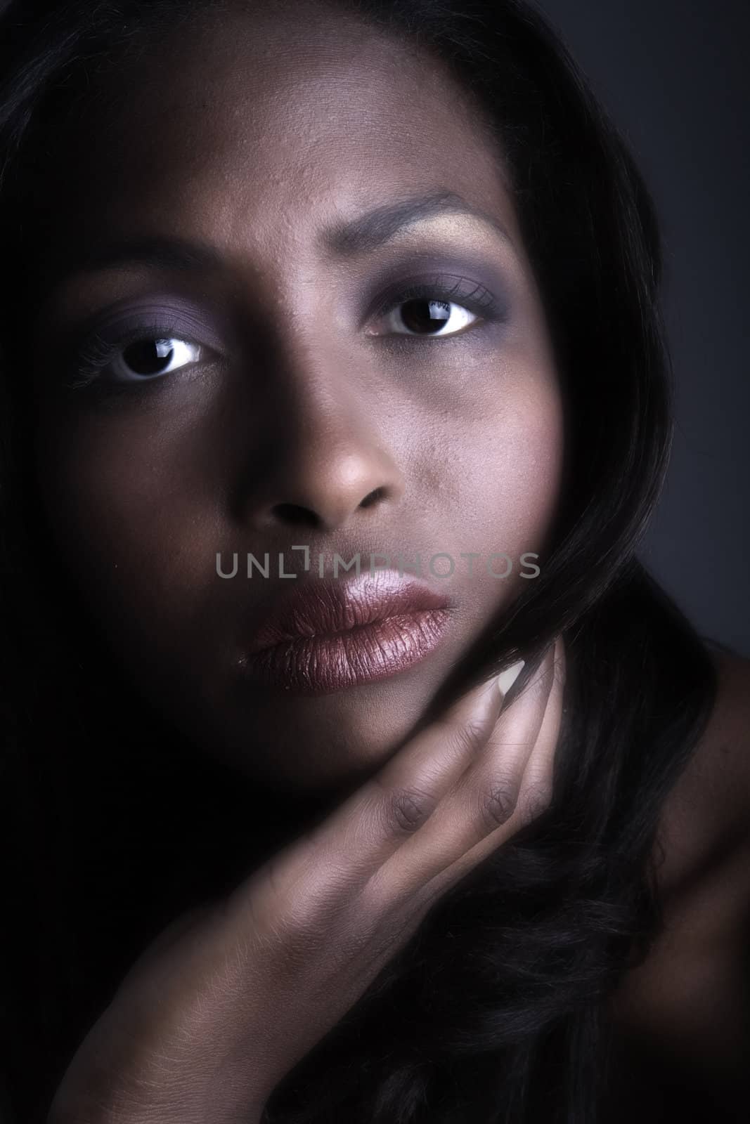 A beauty portrait taken from an african model in the studio looking serious
