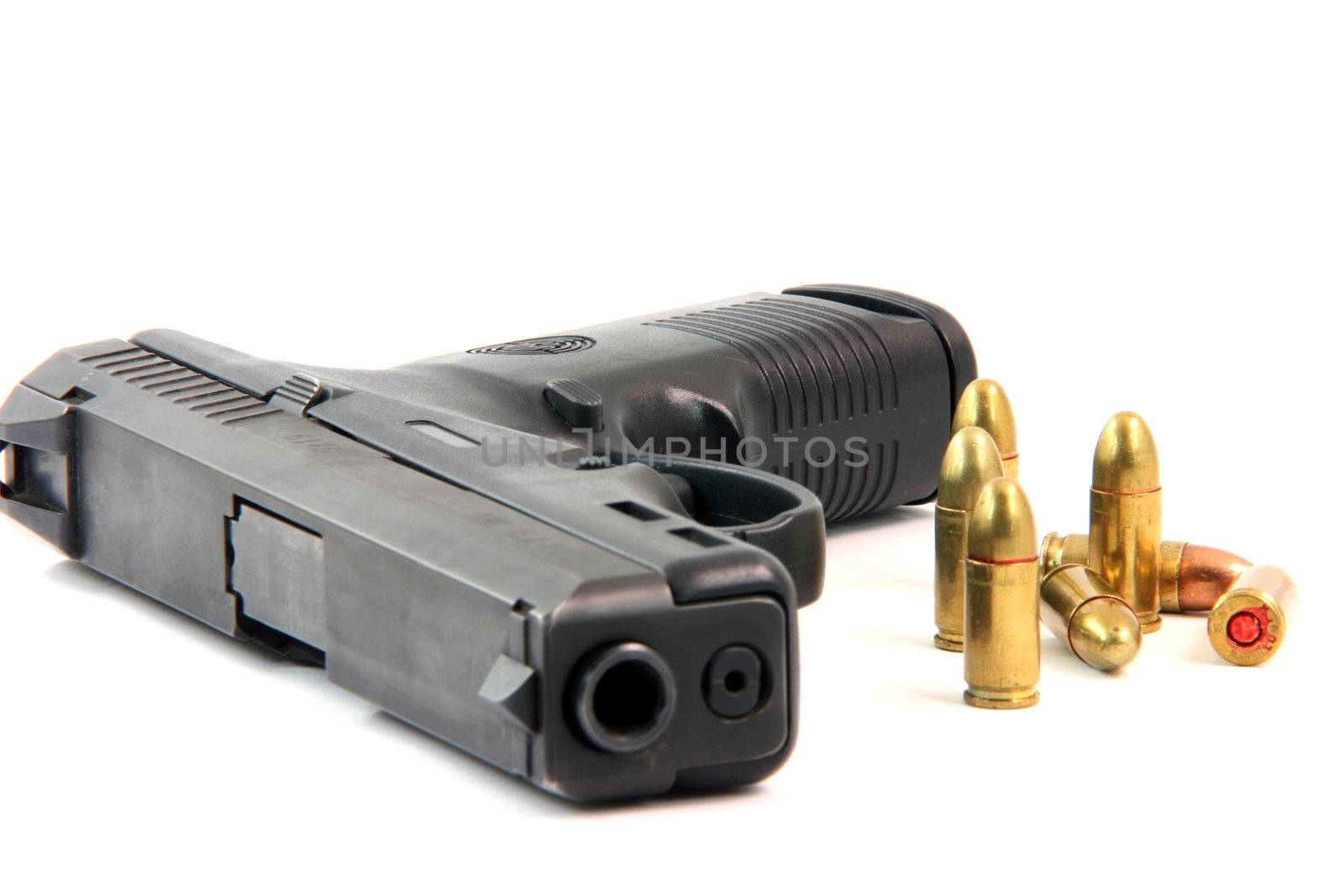 seven bullets and handgun closeup isolated on white background focus on bullets